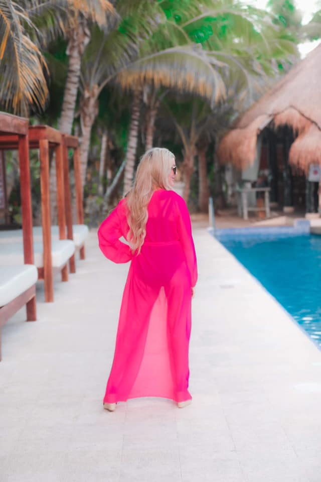 solid pink ultra long coverup made of lightweight, sheer material with an elastic wrist band and a removable tie