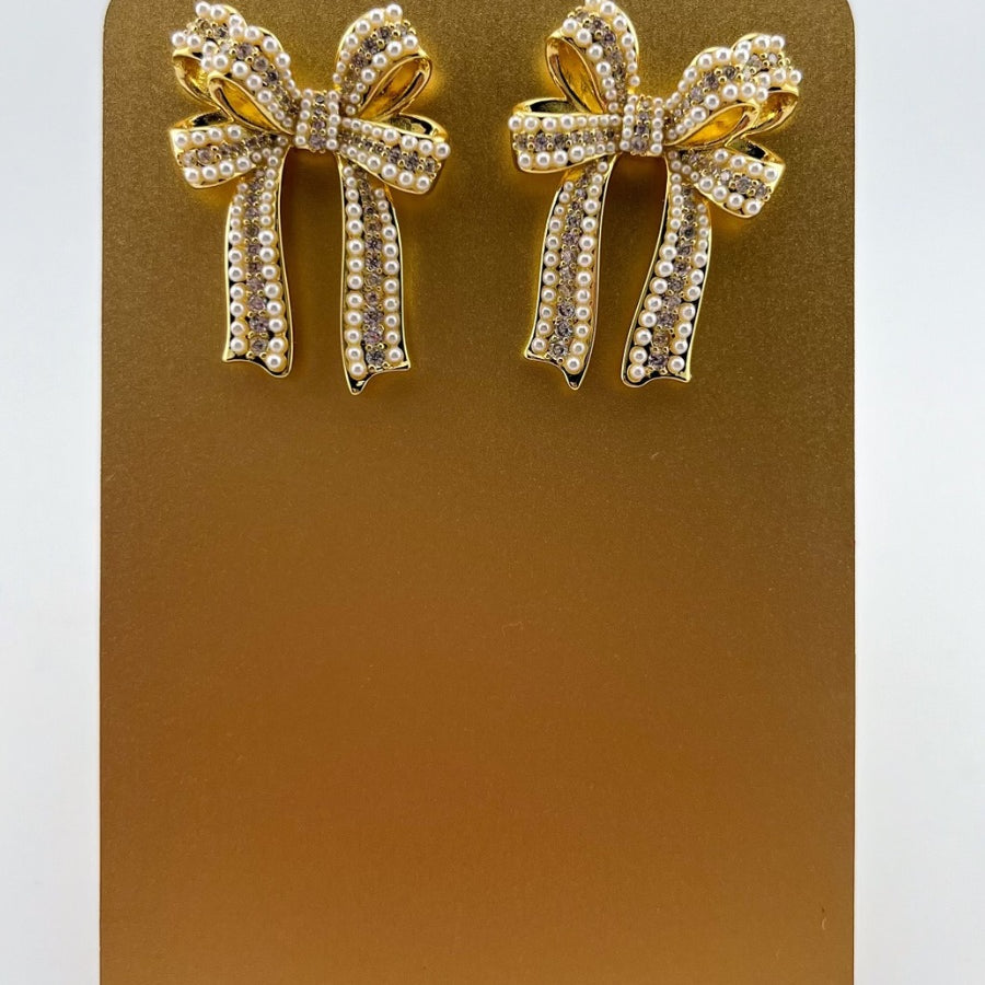 high-quality gold bow post stud earrings with rhinestones and pearl accents and a comfort earring back in gold