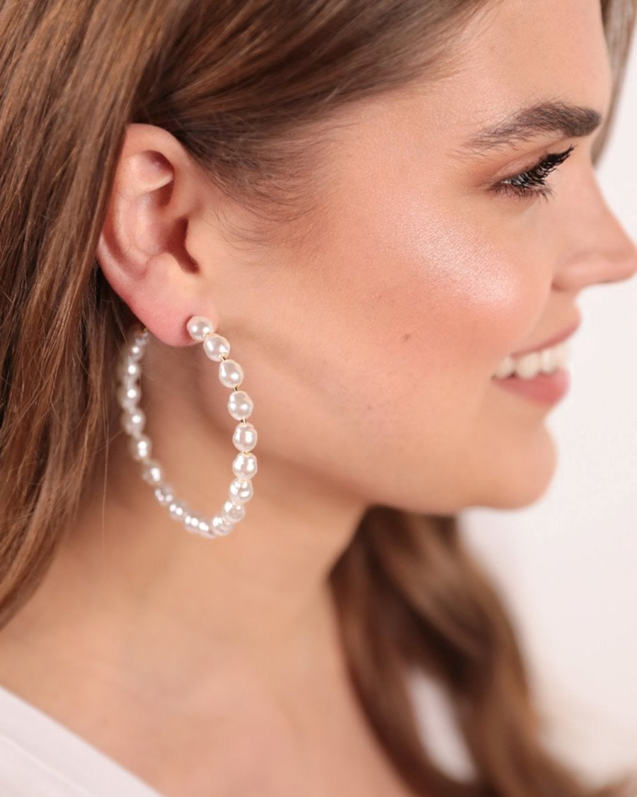 post-stud pearl hoops with a comfort earring back in gold