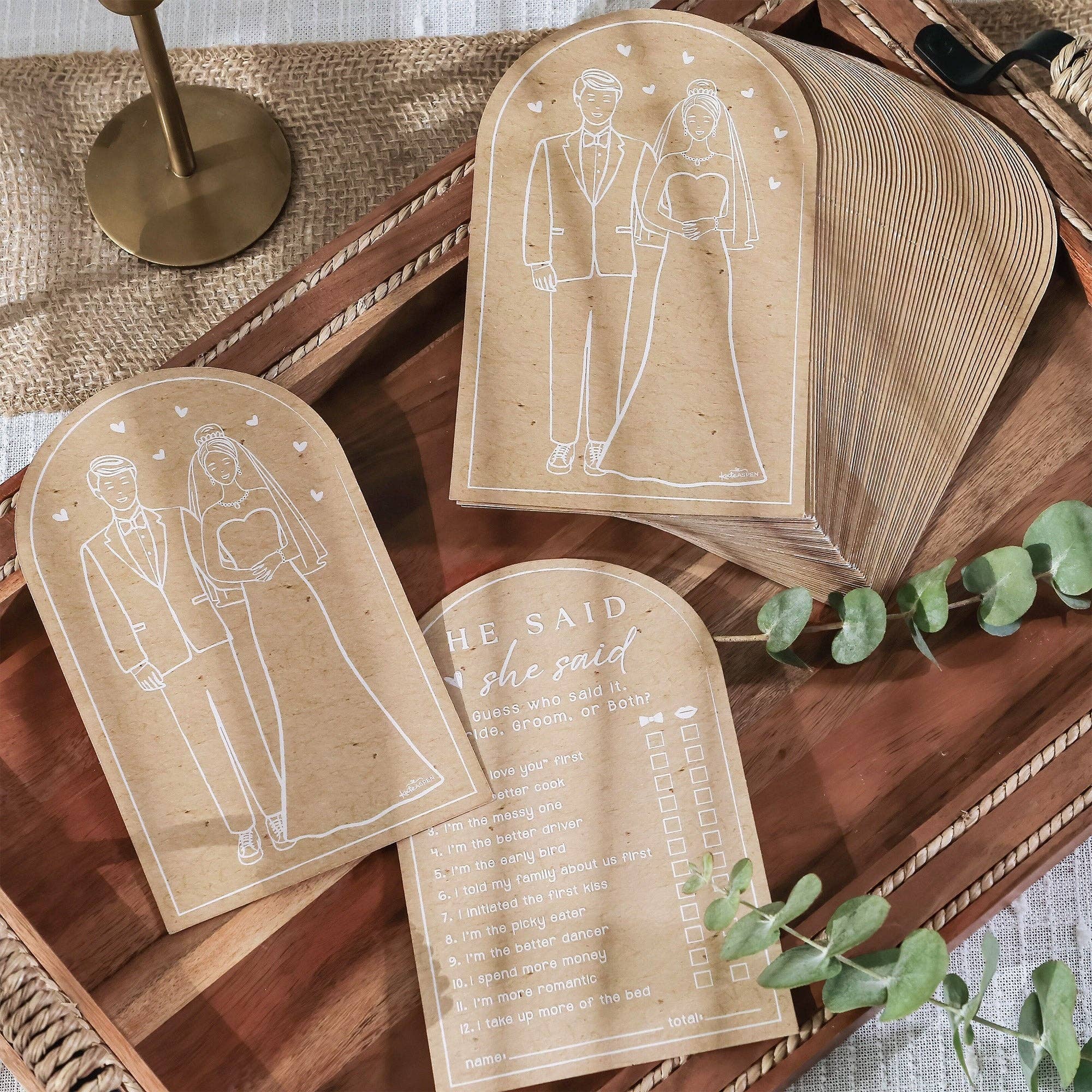 Set of wedding-themed cards with illustrations on a wooden surface.