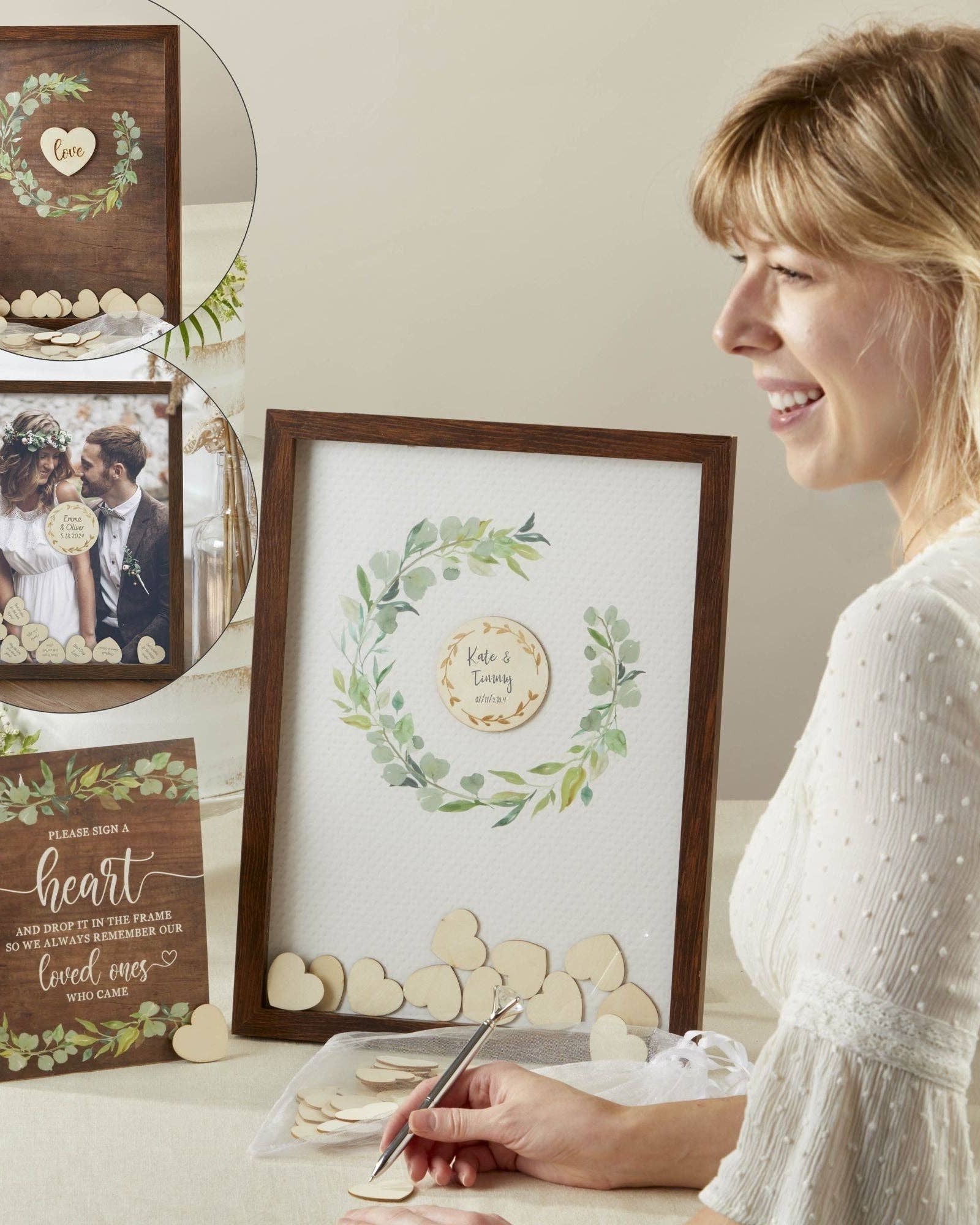 Woman looking at framed wedding photos and decorations on a table.