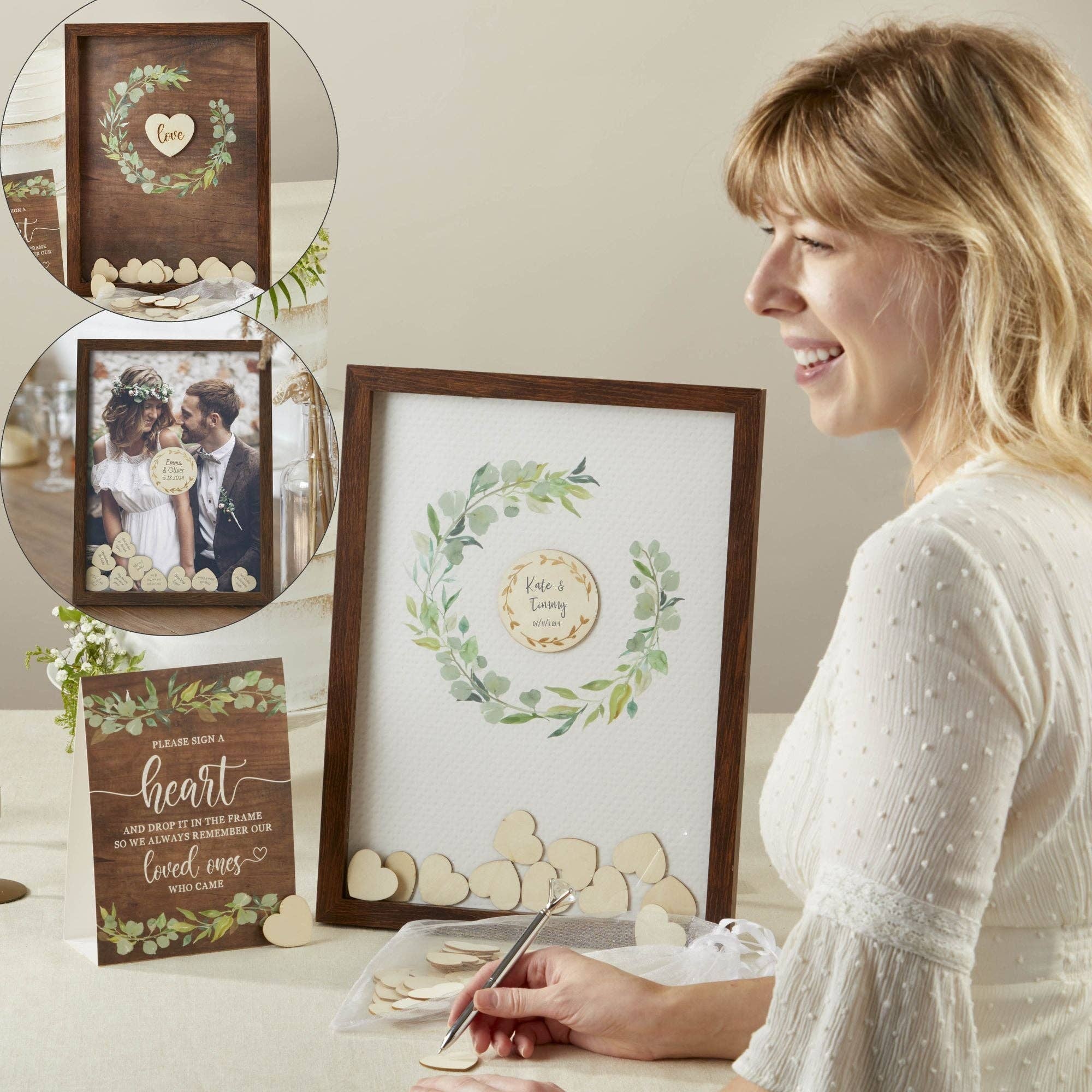 Woman looking at framed wedding photos and decorations on a table.