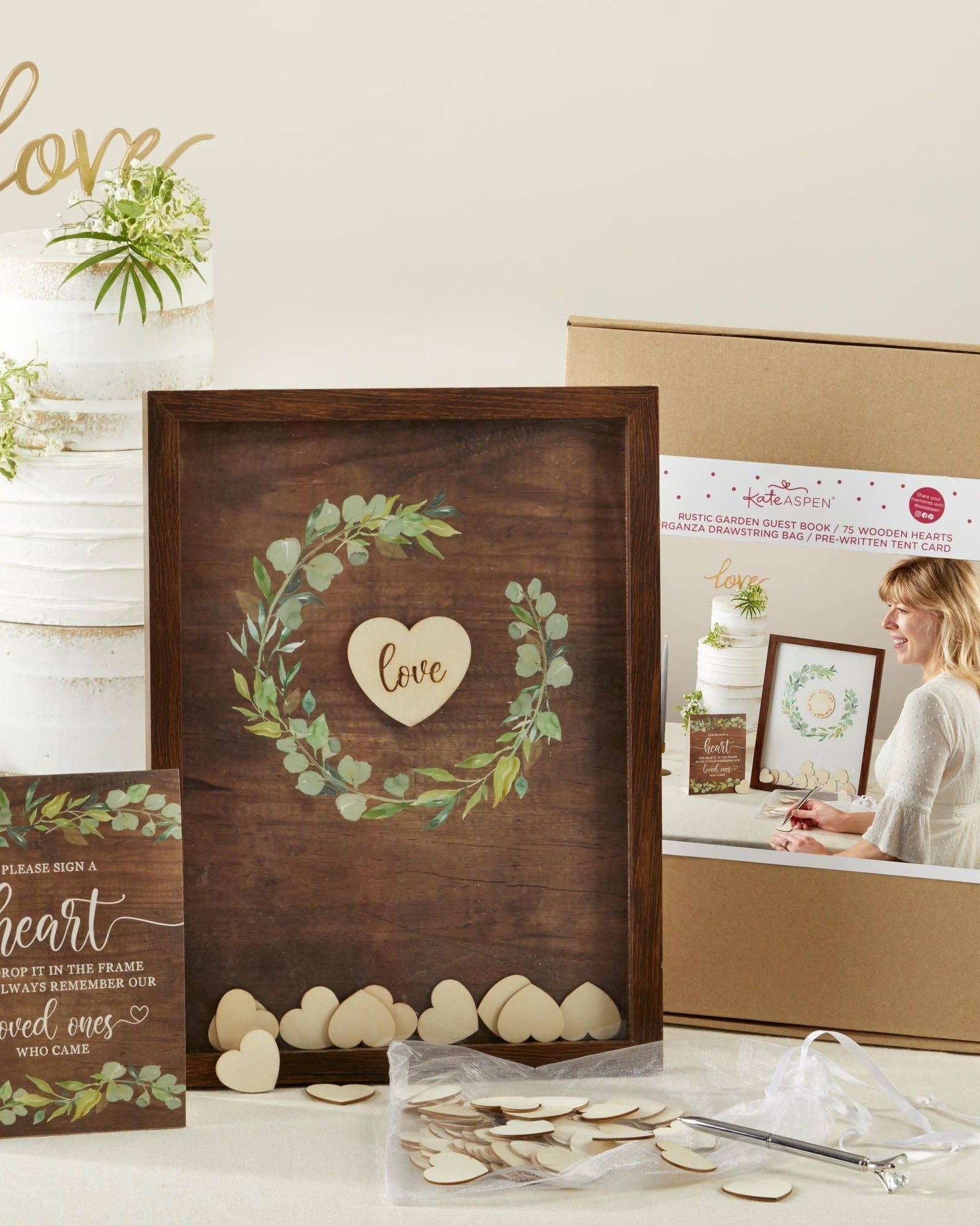 Wooden frame with heart design, packaging box, and decorative items on a light background