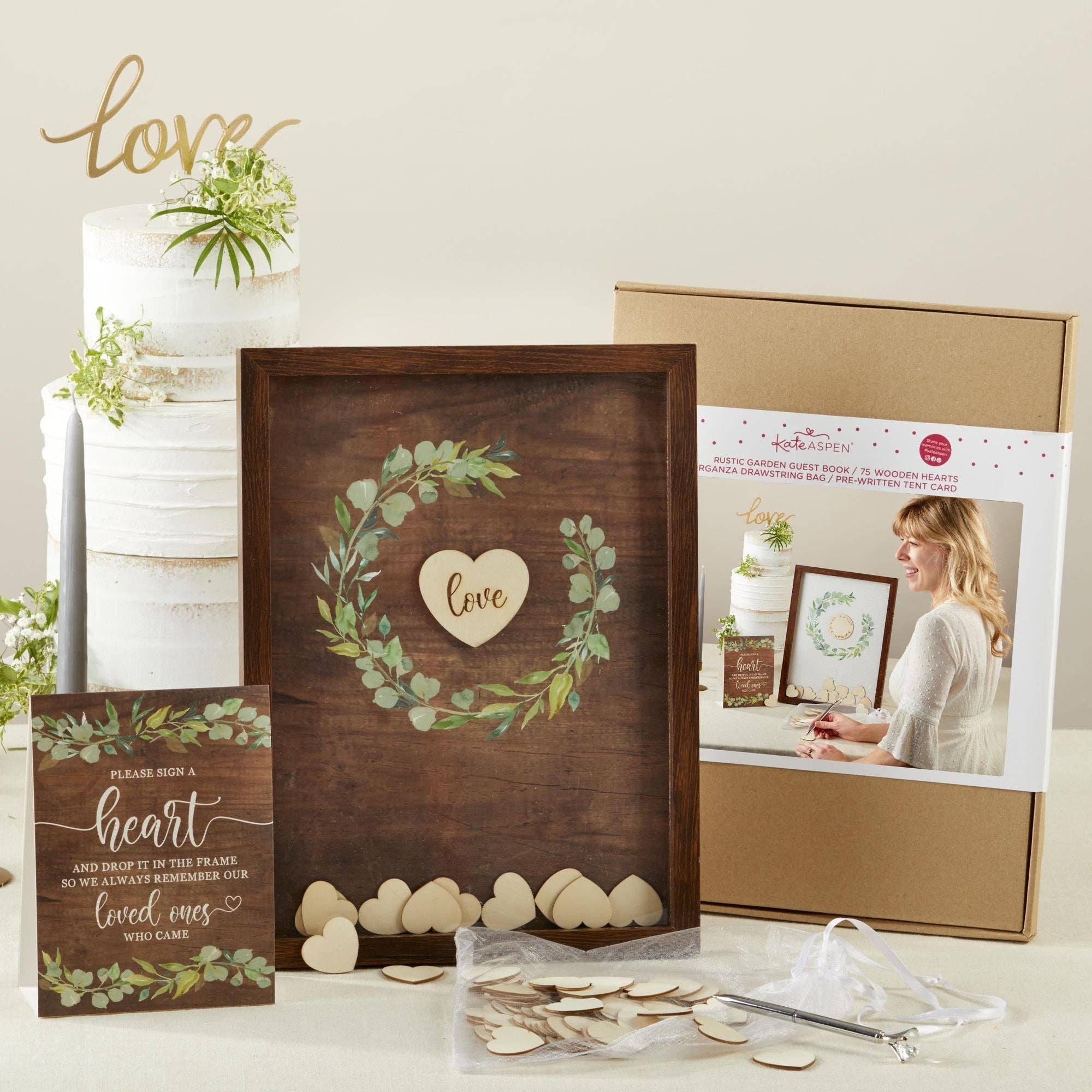 Wooden frame with heart design, packaging box, and decorative items on a light background