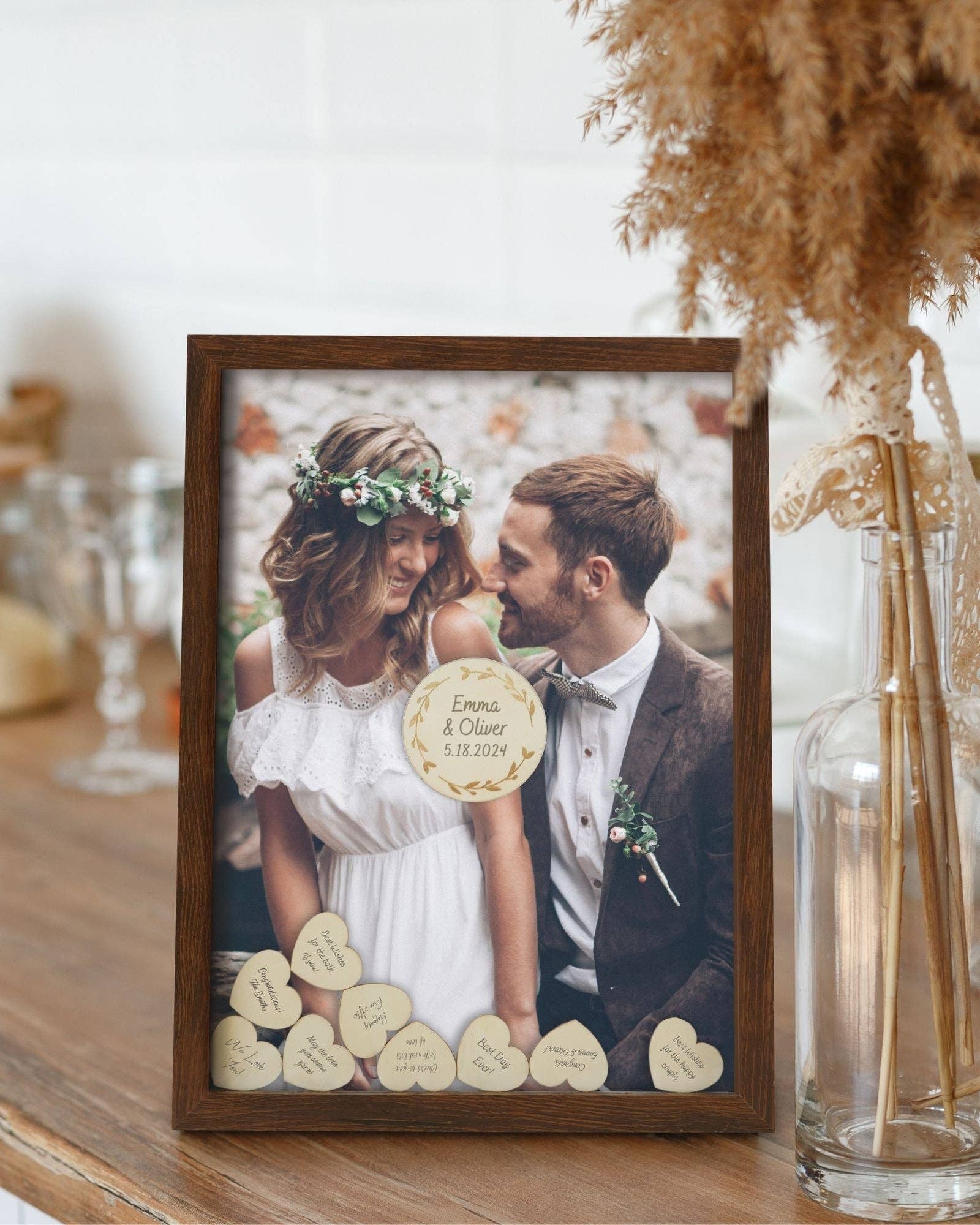 Framed photo of a couple with wooden heart decorations on a table.