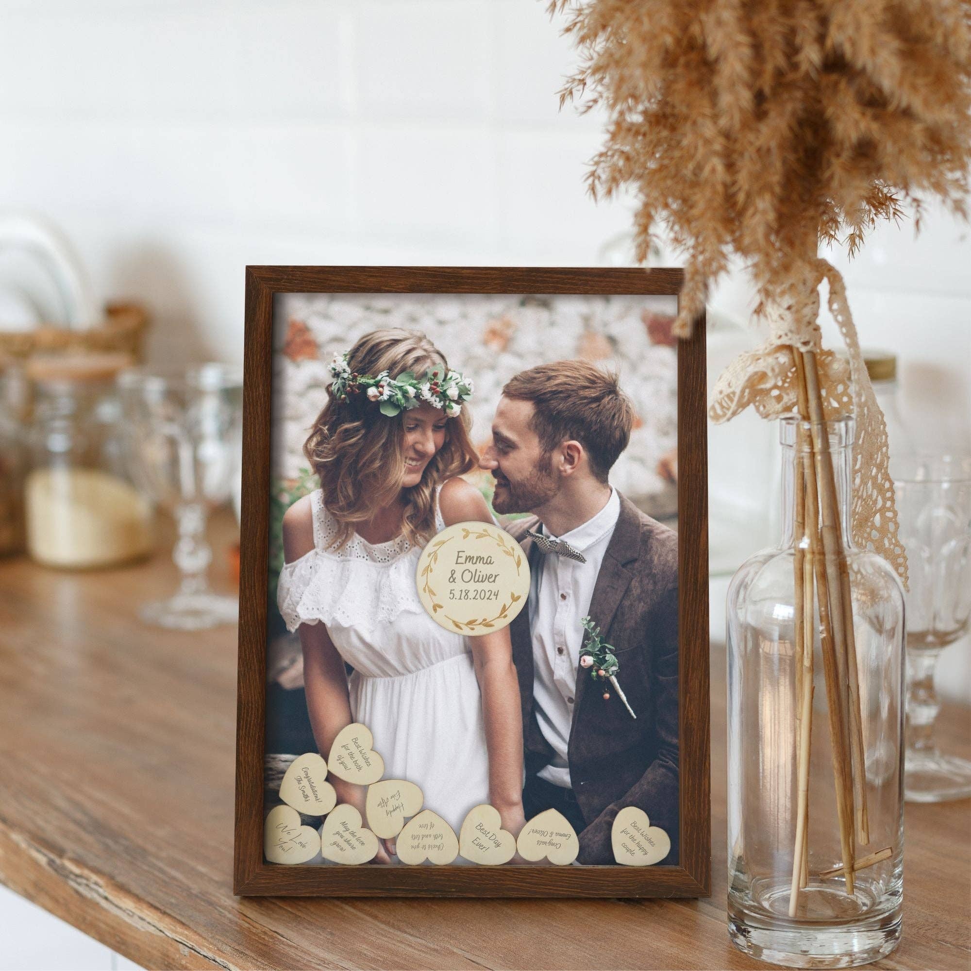 Framed photo of a couple with wooden heart decorations on a table.