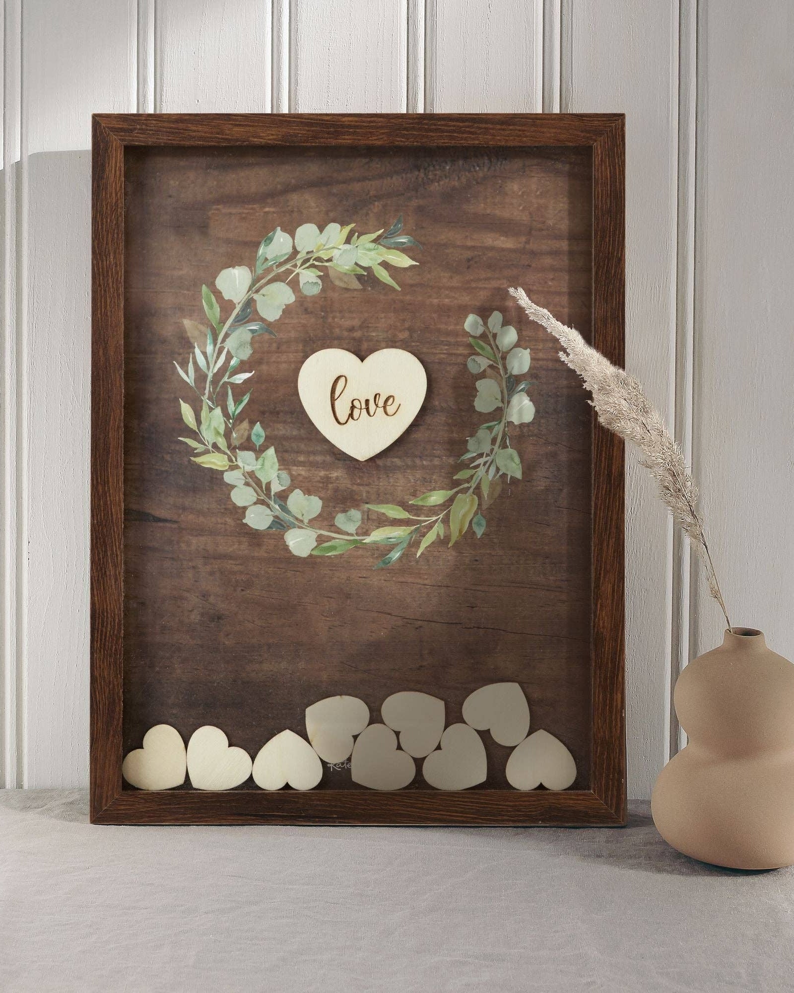 Wooden wall art with heart design and 'love' text, placed on a light wooden floor.
