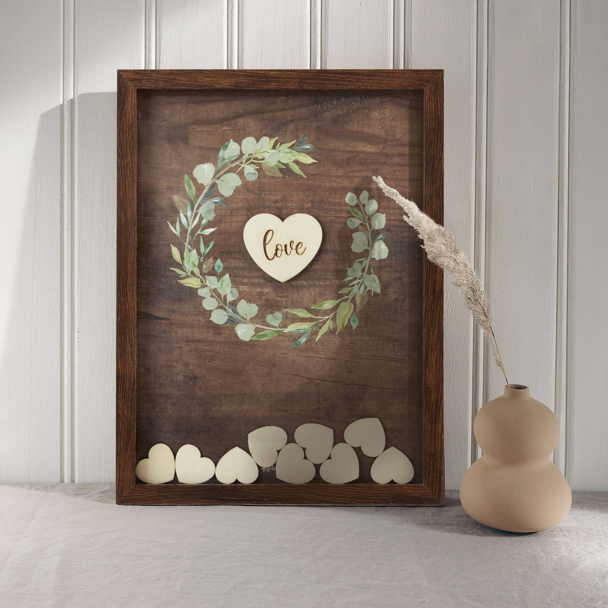 Wooden wall art with heart design and 'love' text, placed on a light wooden floor.