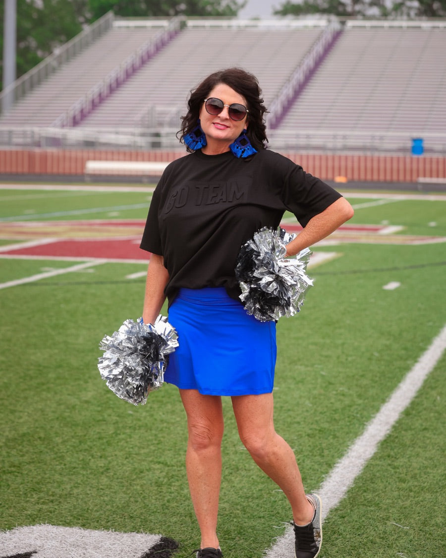 a slimming true to size solid royal blue skort with built-in shorts, interior side pockets, and a pleated back