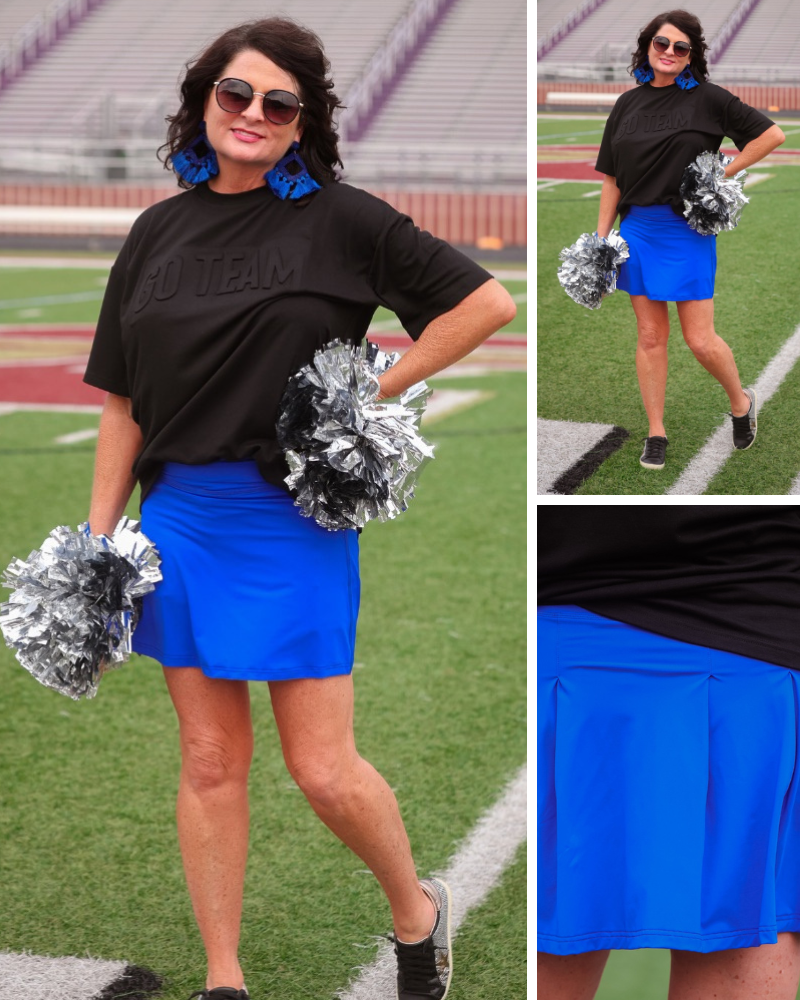 a royal blue true-to-size tennis skort designed with a slimming fit, built-in shorts, interior side pockets, smooth stretch fabric, pleated back, high rise waistband, and mini length