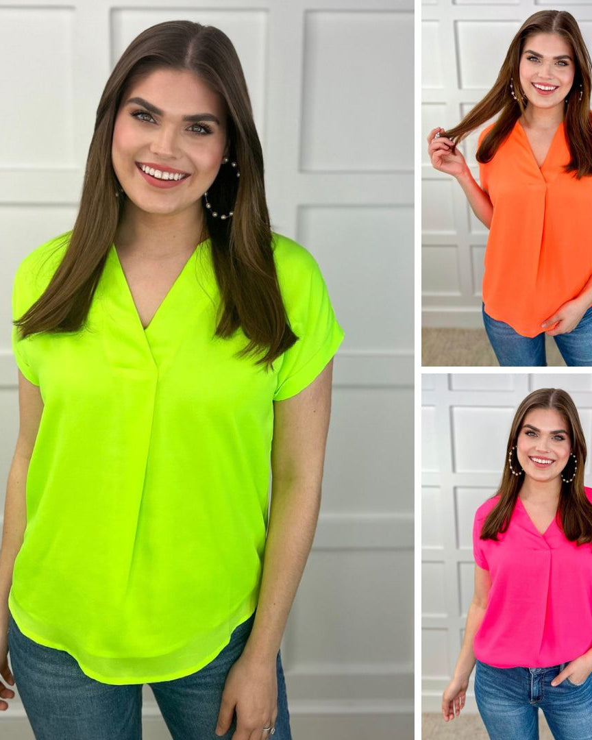 vibrant blouses made of lightweight woven fabric blouse with a flattering draped silhouette, a contemporary V-neckline, rolled short sleeves, a fully lined interior, and no stretch in neon lime, neon orange, and neon pink