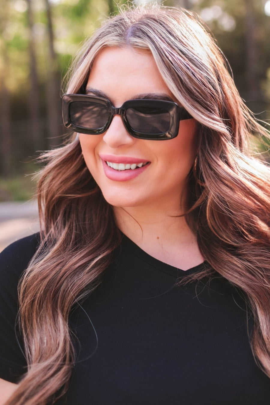 black chunky rectangular sunglasses with thick frames, tinted lenses, smooth finish, UV protection, and brand detail (on both the temple and the complimentary black pouch)