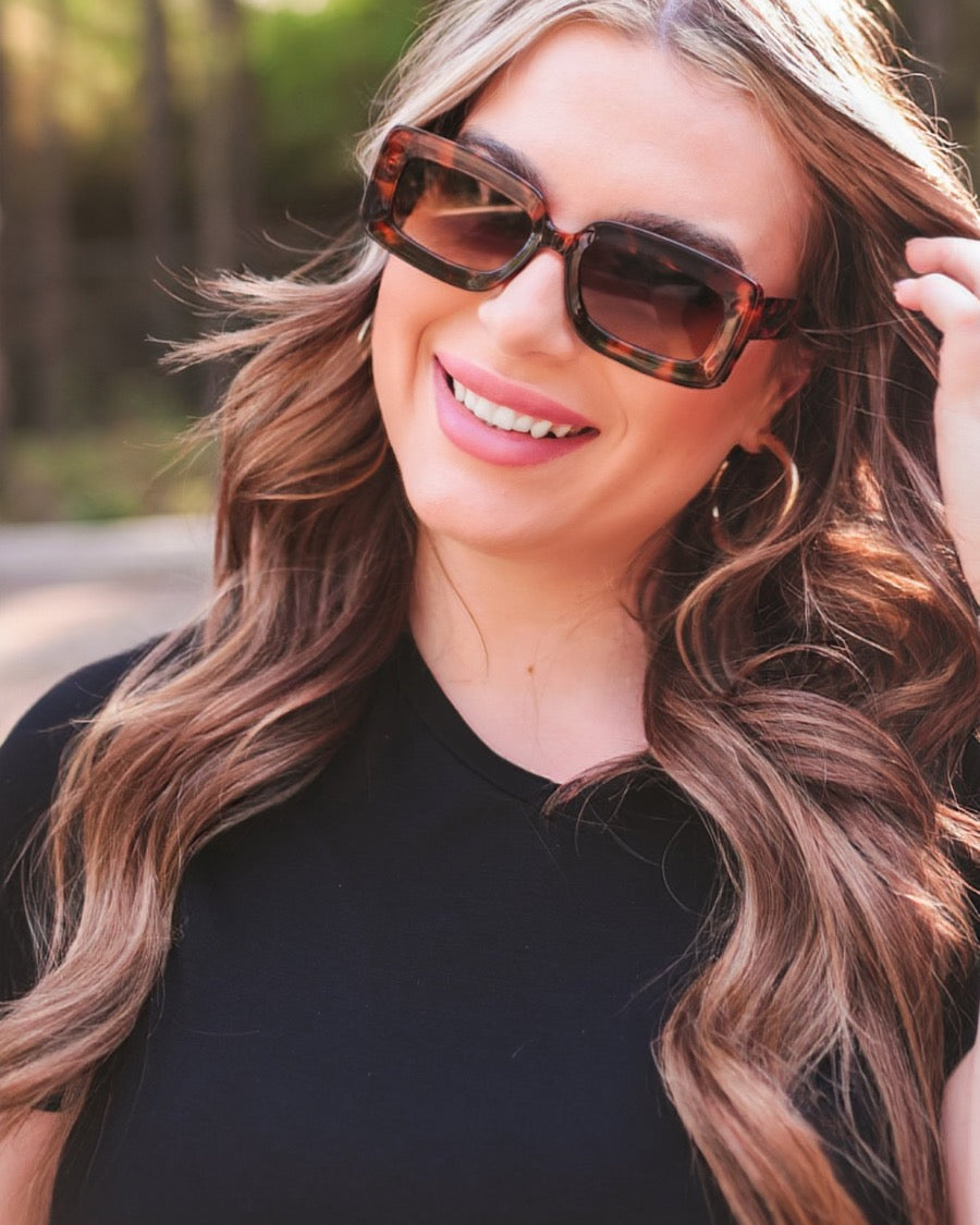 brown chunky rectangular sunglasses with thick frames, tinted lenses, smooth finish, UV protection, and brand detail (on both the temple and the complimentary black pouch)