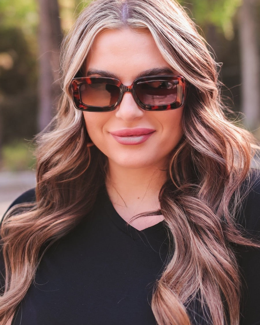 brown chunky rectangular sunglasses with thick frames, tinted lenses, smooth finish, UV protection, and brand detail (on both the temple and the complimentary black pouch)