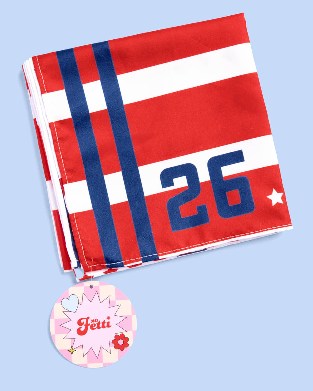 a soft lightweight square polyester bandana with a red, white, and blue flag-inspired print, stars, strips, Team USA lettering, and versatile styling options