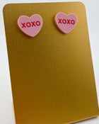 ink candy heart-inspired earrings shaped like hearts with 'XOXO' lettering in the center
