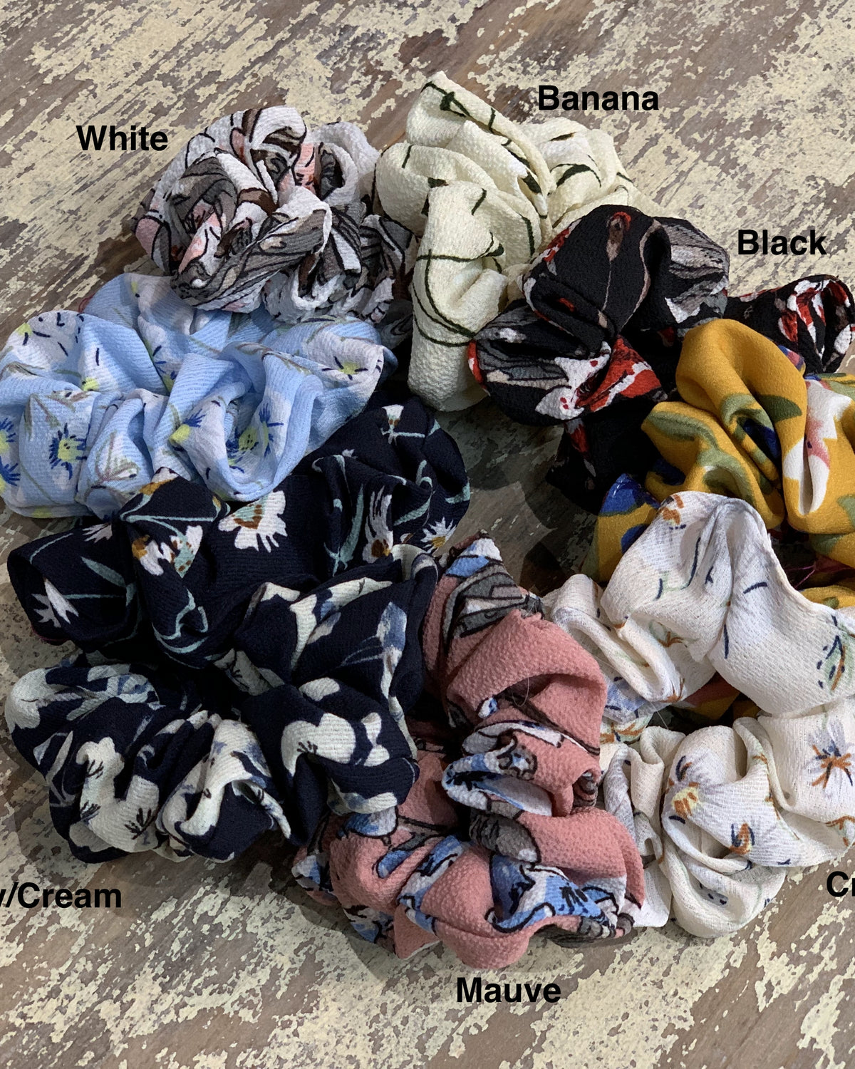 oversized floral scrunchies with lightweight textured fabric, gathered construction, gentle hair-friendly hold, and easy pull-on styling in banana, black, butterscotch, cream, mauve, navy cream, navy teal, sky, and white