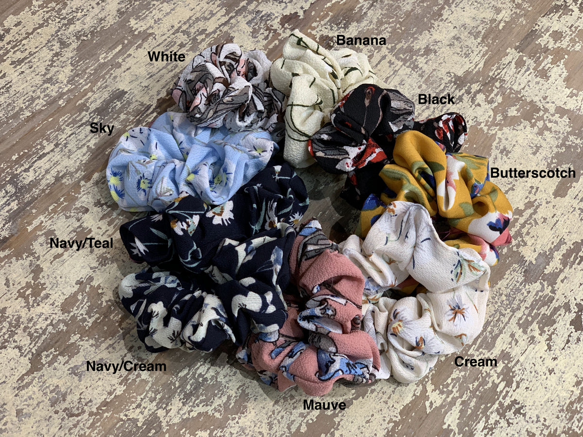 oversized floral scrunchies with lightweight textured fabric, gathered construction, gentle hair-friendly hold, and easy pull-on styling in banana, black, butterscotch, cream, mauve, navy cream, navy teal, sky, and white