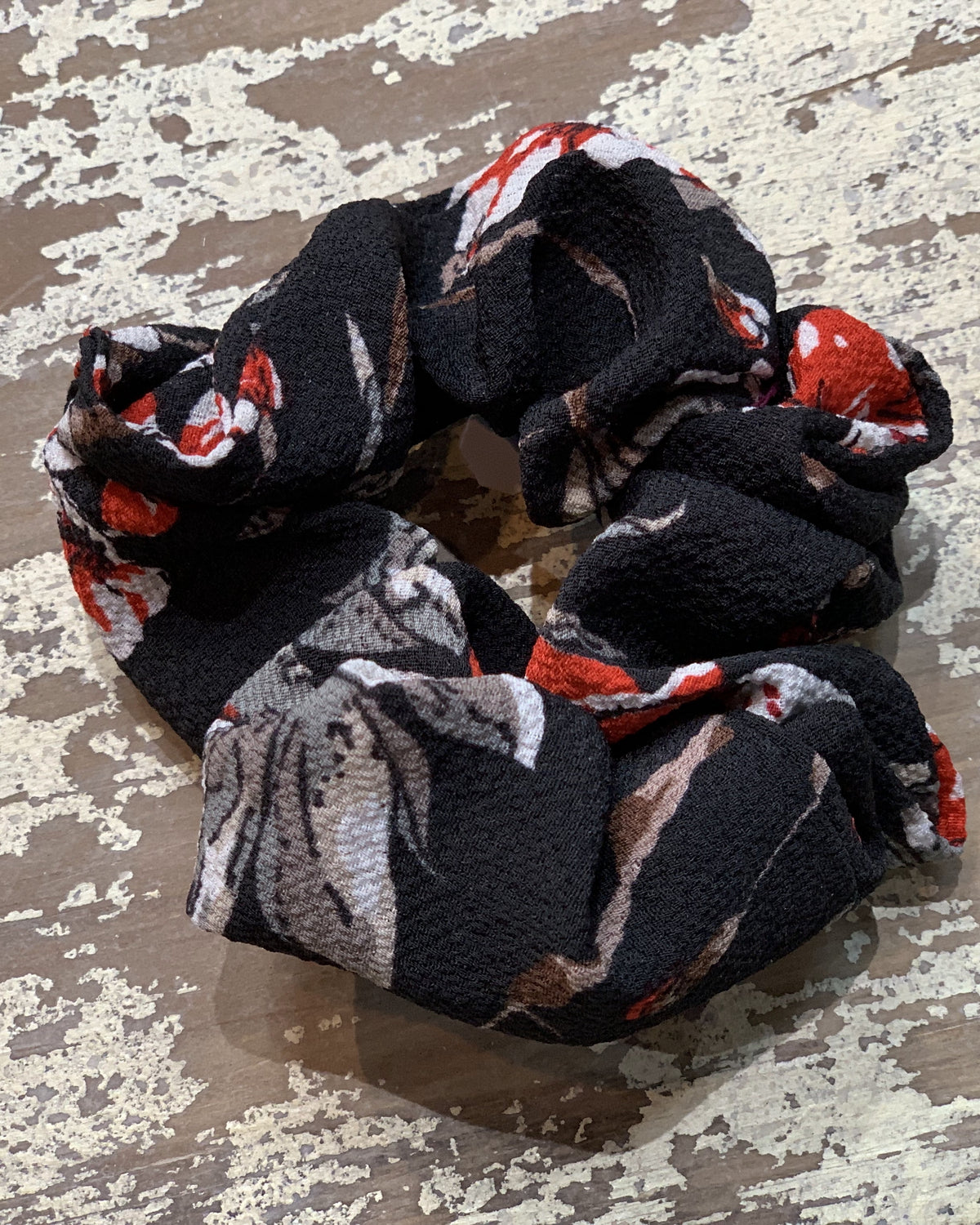 an oversized floral scrunchie with lightweight textured fabric, gathered construction, gentle hair-friendly hold, and easy pull-on styling in black