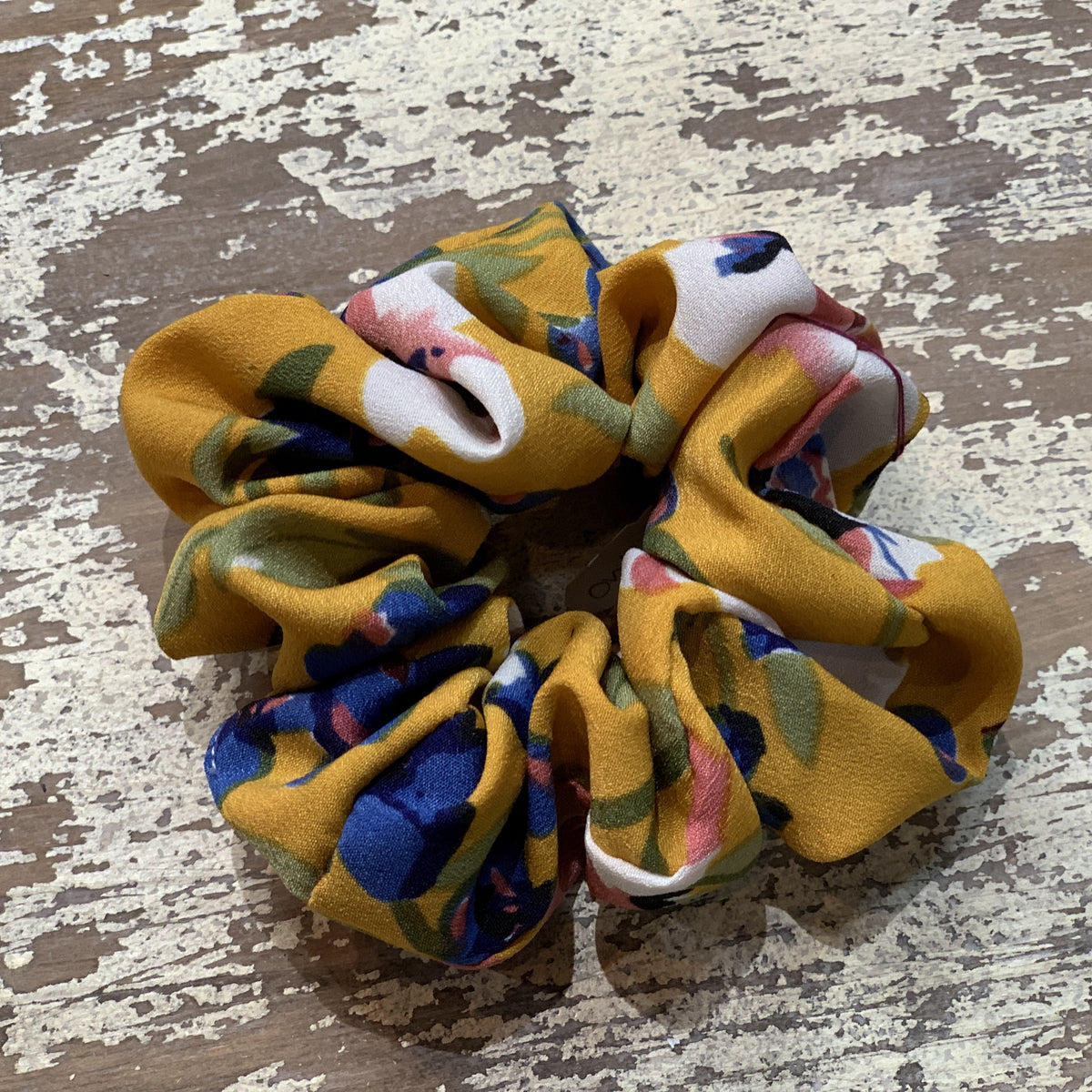 an oversized floral scrunchie with lightweight textured fabric, gathered construction, gentle hair-friendly hold, and easy pull-on styling in butterscotch