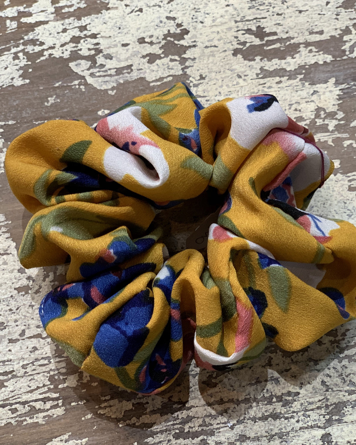 an oversized floral scrunchie with lightweight textured fabric, gathered construction, gentle hair-friendly hold, and easy pull-on styling in butterscotch
