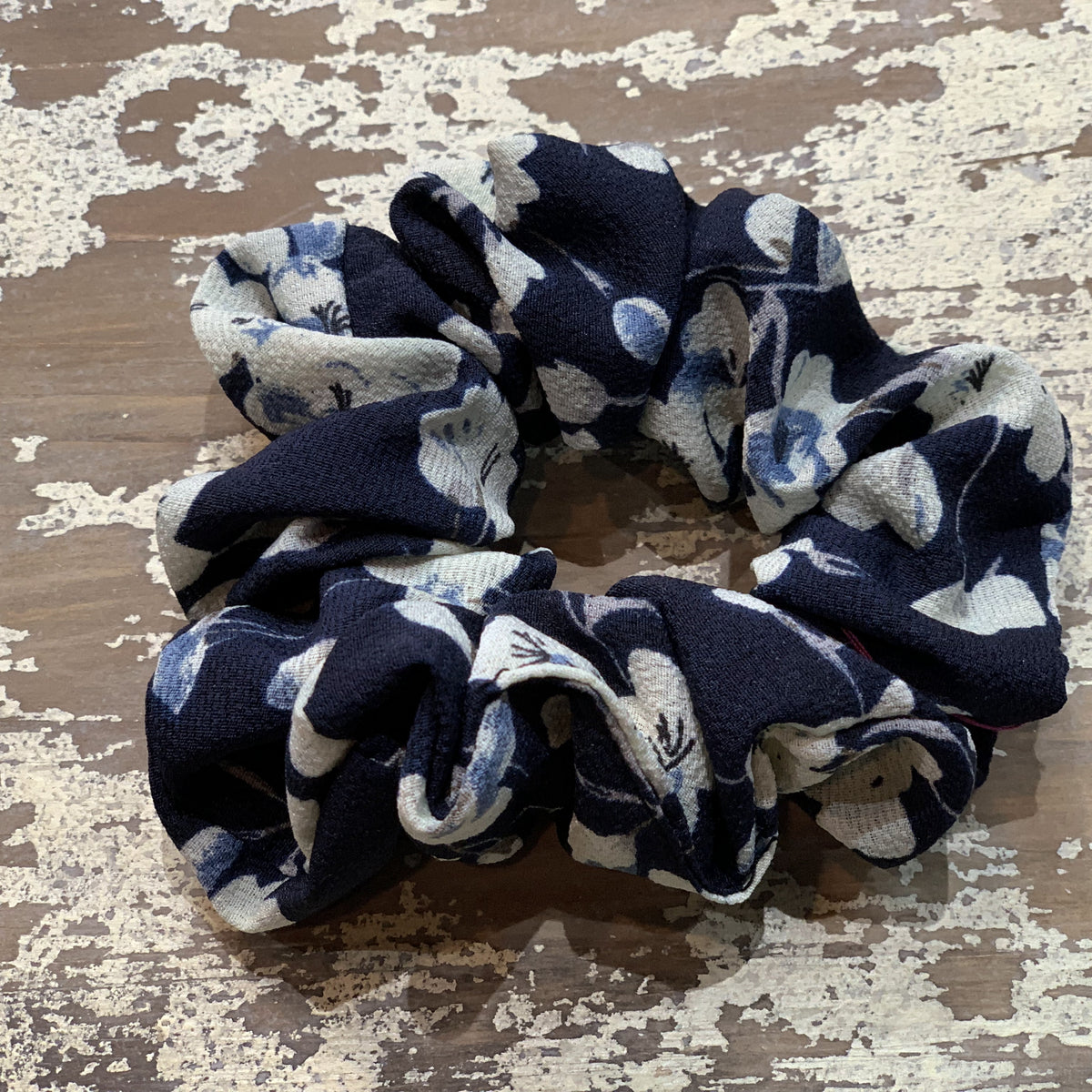 an oversized floral scrunchie with lightweight textured fabric, gathered construction, gentle hair-friendly hold, and easy pull-on styling in navy cream