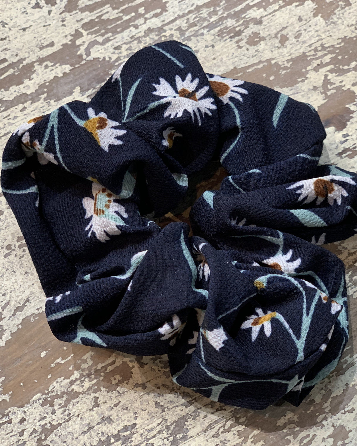 an oversized floral scrunchie with lightweight textured fabric, gathered construction, gentle hair-friendly hold, and easy pull-on styling in navy teal
