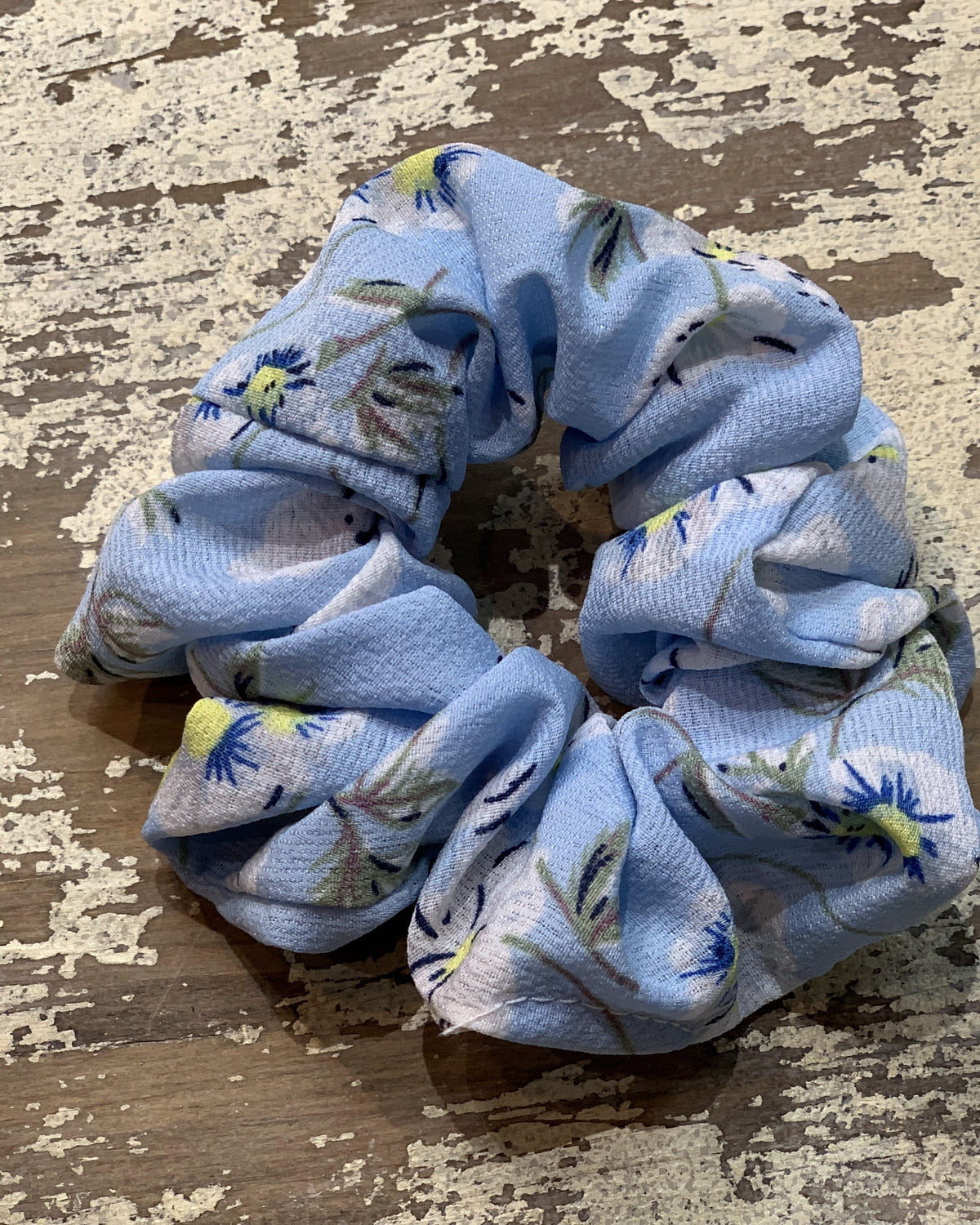 an oversized floral scrunchie with lightweight textured fabric, gathered construction, gentle hair-friendly hold, and easy pull-on styling in sky