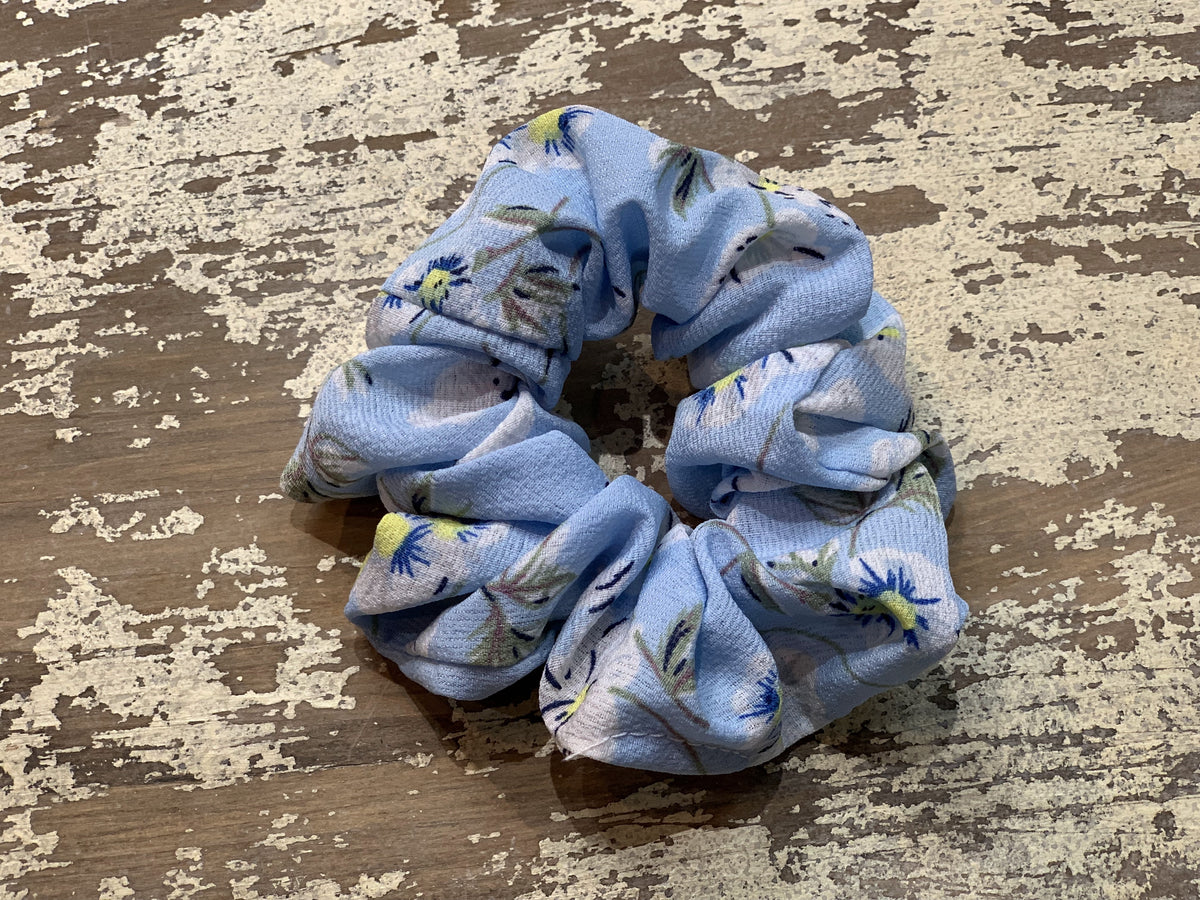 an oversized floral scrunchie with lightweight textured fabric, gathered construction, gentle hair-friendly hold, and easy pull-on styling in sky