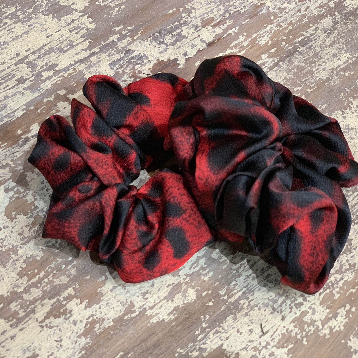 an oversized satin-look leopard scrunchie with glossy animal print fabric, plush gathered construction, lightweight feel, and gentle hair-friendly hold in leopard rose