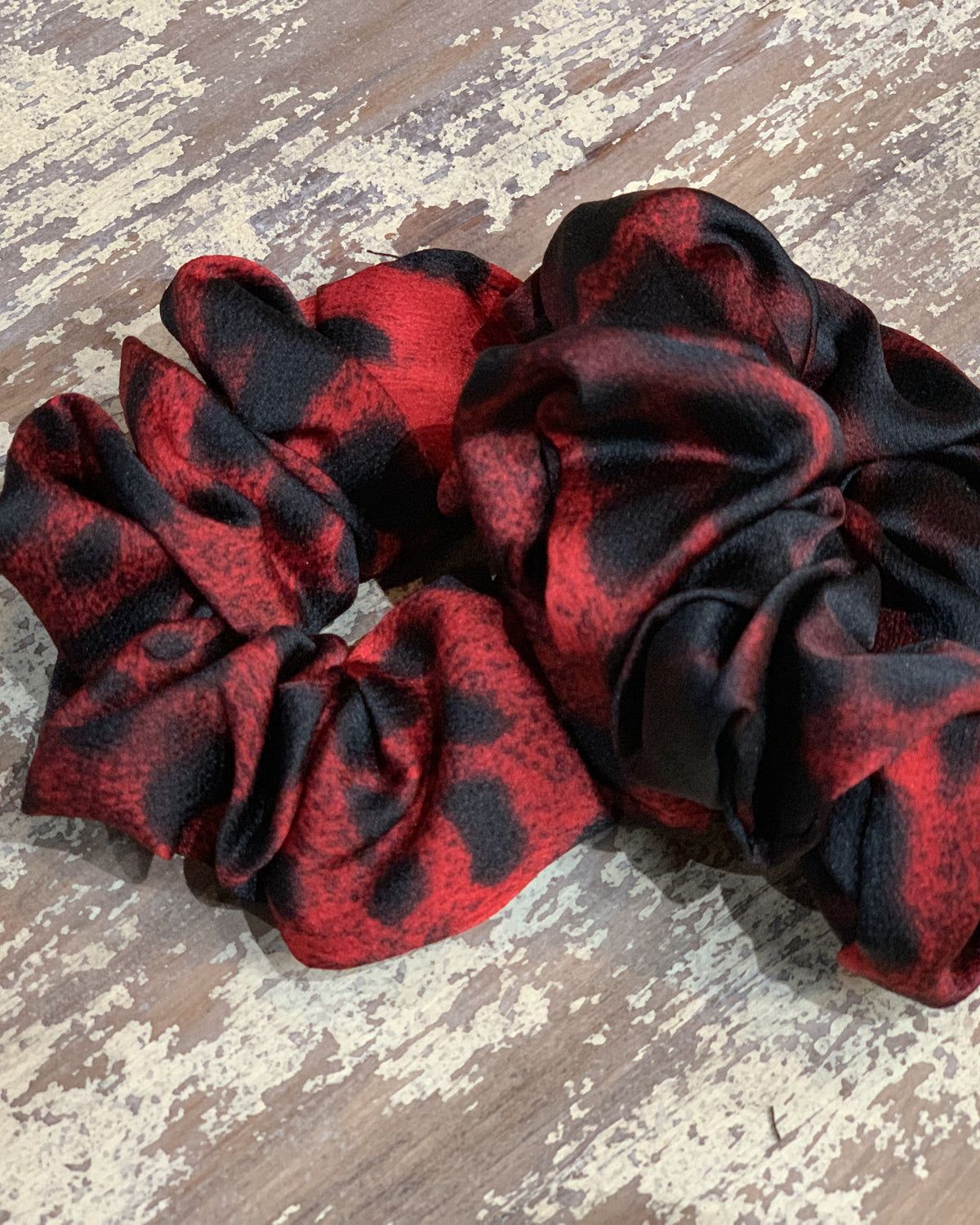 an oversized satin-look leopard scrunchie with glossy animal print fabric, plush gathered construction, lightweight feel, and gentle hair-friendly hold in leopard rose