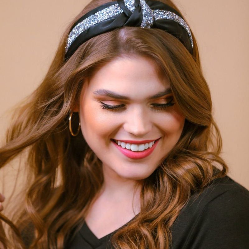 a twisted center knot with rhinestones lining the headband's center in black