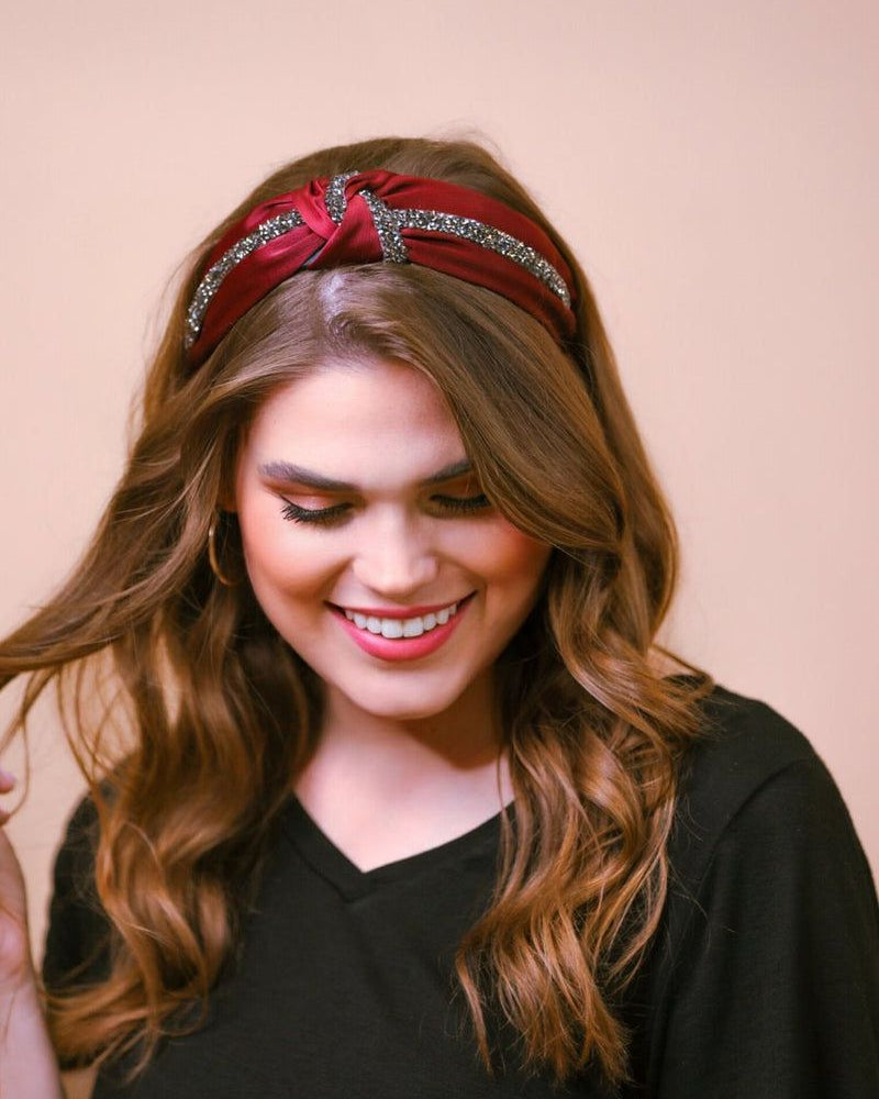 a twisted center knot with rhinestones lining the headband's center in burgundy