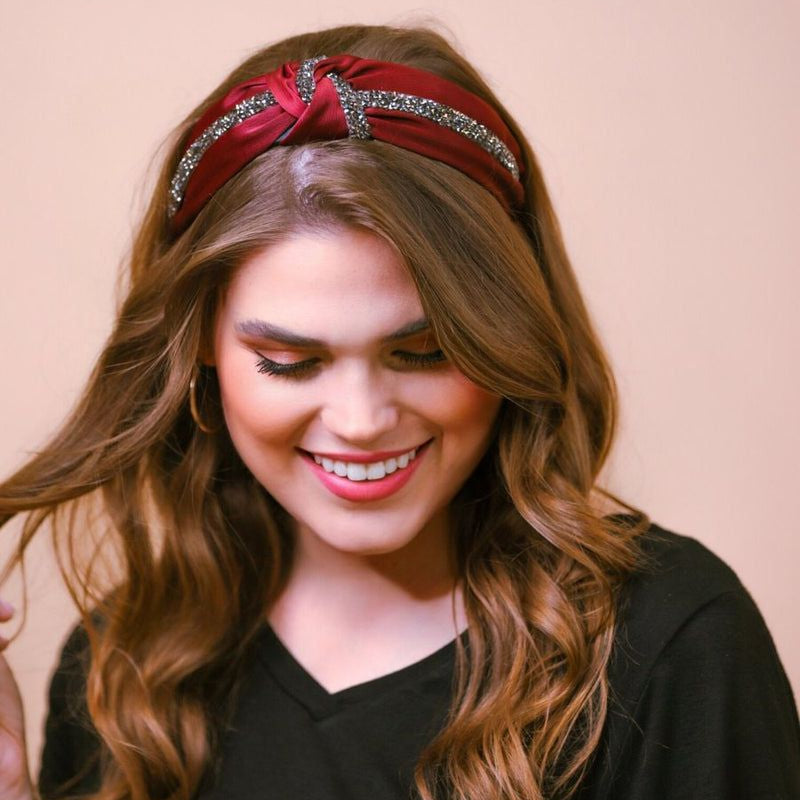 a twisted center knot with rhinestones lining the headband's center in burgundy
