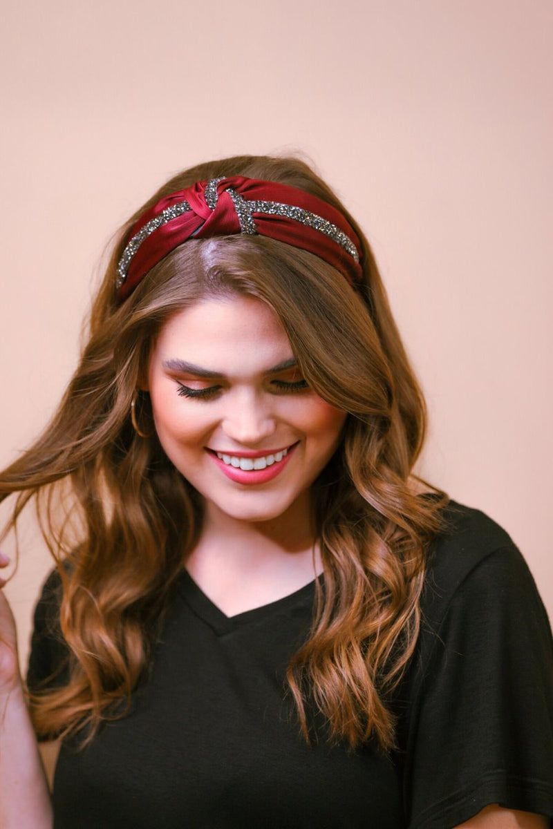 a twisted center knot with rhinestones lining the headband's center in burgundy