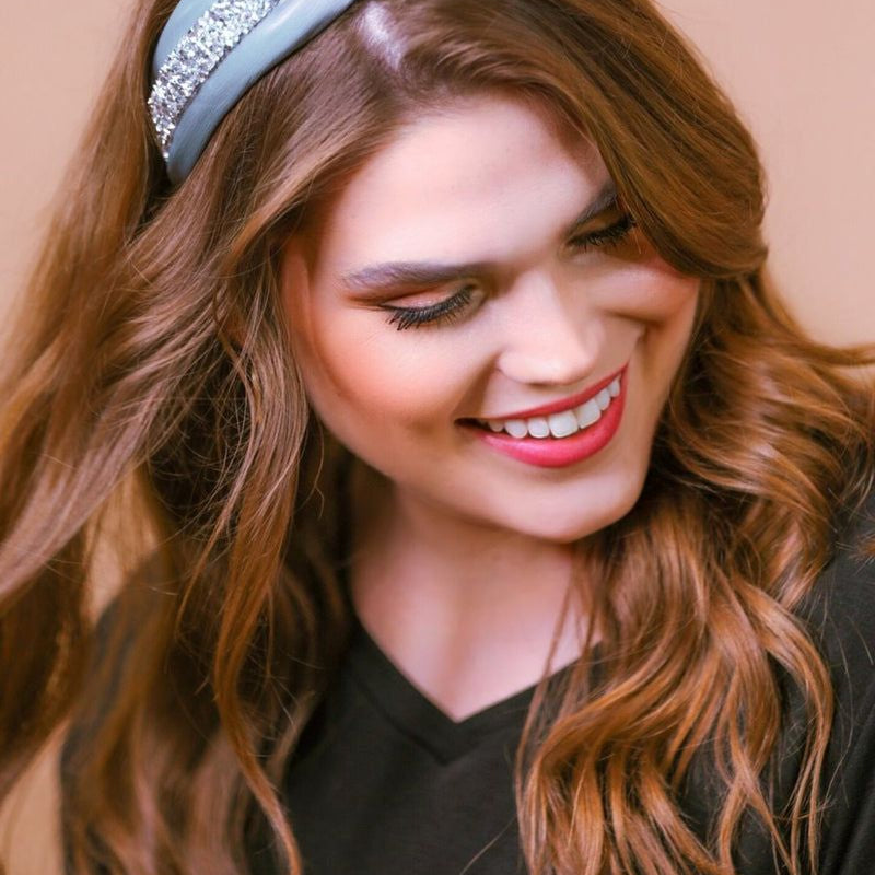 a twisted center knot with rhinestones lining the headband's center in grey