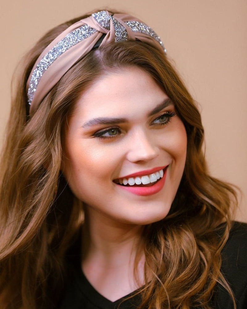 a twisted center knot with rhinestones lining the headband's center in tan
