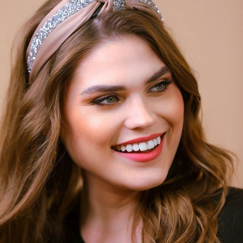 a twisted center knot with rhinestones lining the headband's center in tan
