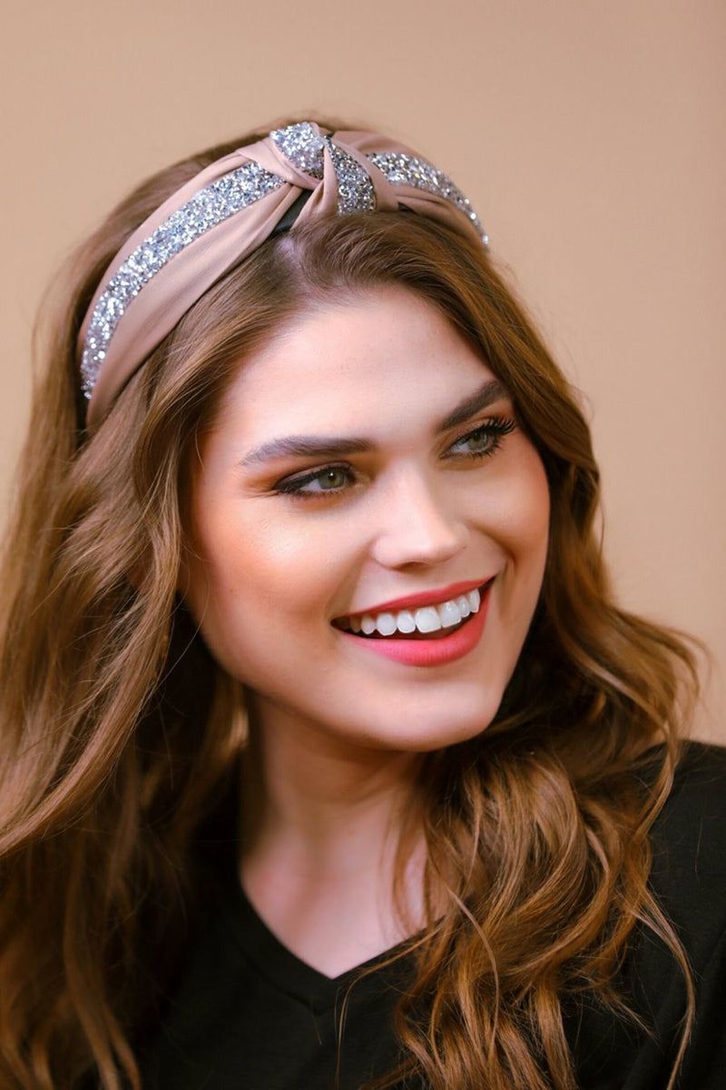 a twisted center knot with rhinestones lining the headband's center in tan