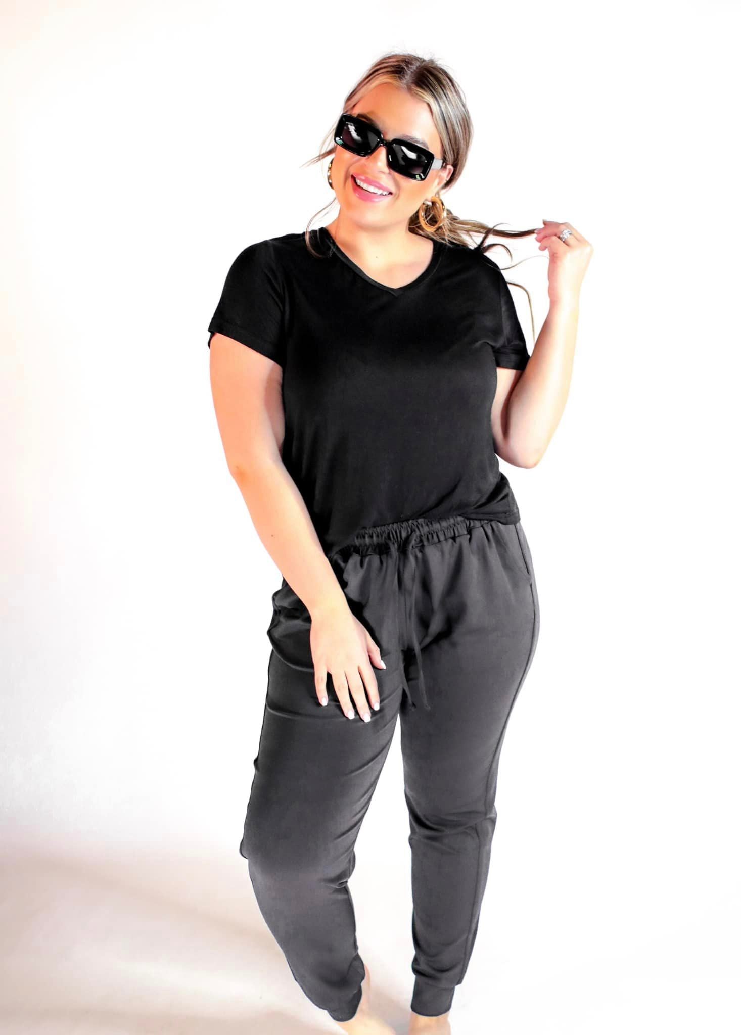 mid-rise joggers with a relaxed fit, an adjustable drawstring waist, and black banded ankles, accented with black trim on our best-selling sublimation printed everyday fabric base in a sleek solid black