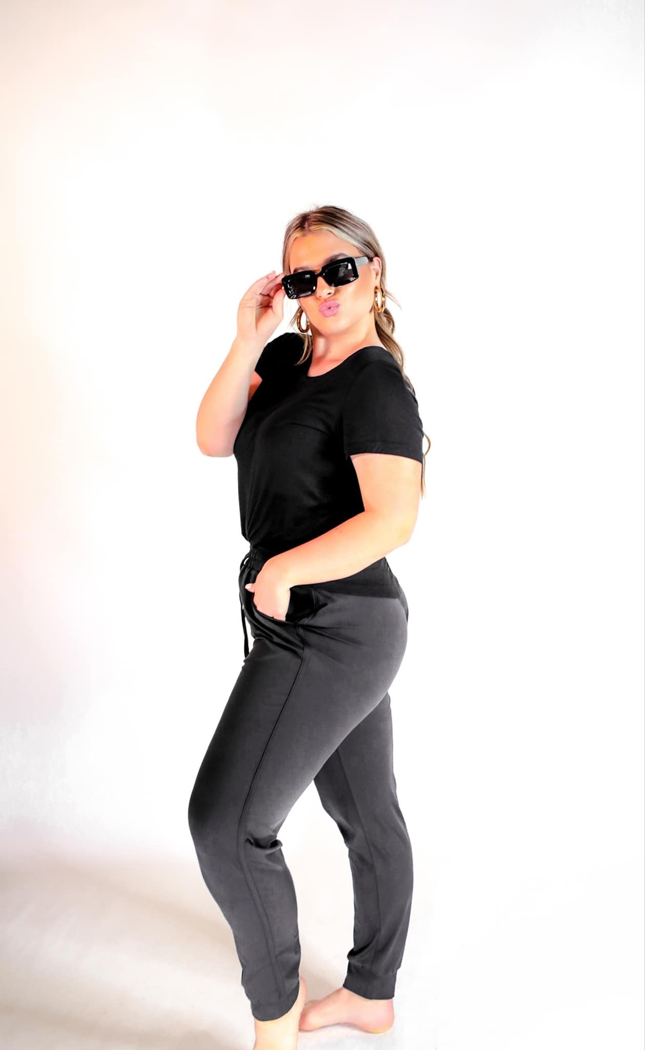 mid-rise joggers with a relaxed fit, an adjustable drawstring waist, and black banded ankles, accented with black trim on our best-selling sublimation printed everyday fabric base in a sleek solid black