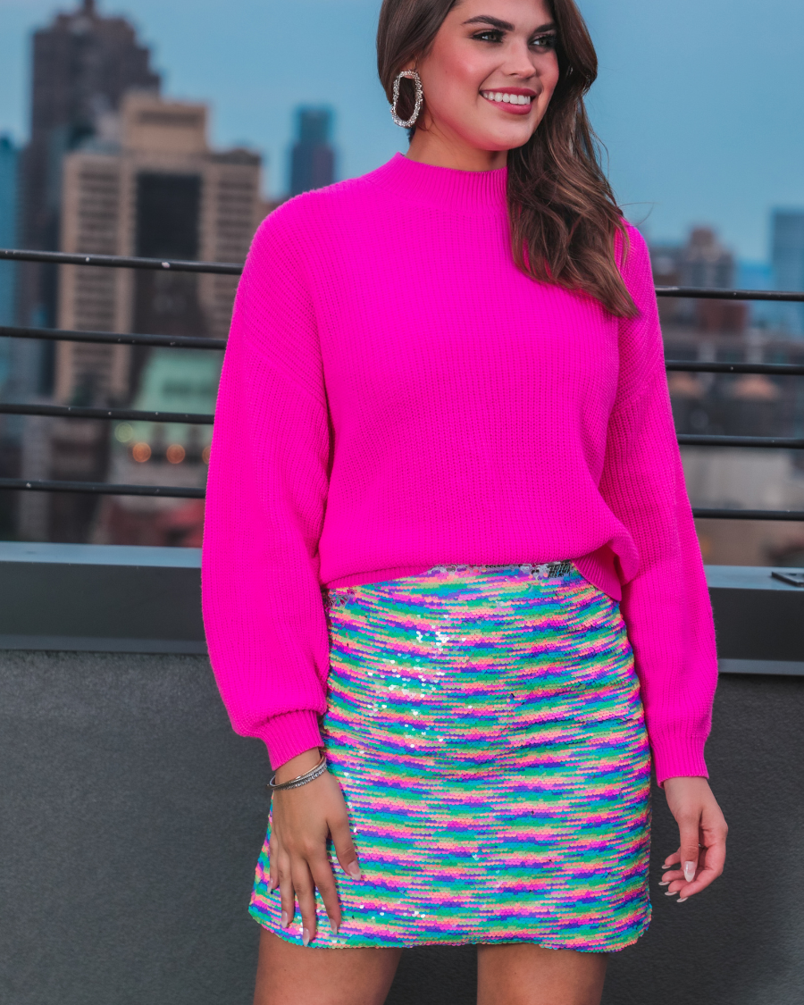 a lightweight high-waisted skirt covered in shimmering multicolor reversible sequins, a smooth interior lining, and a back discreet zipper