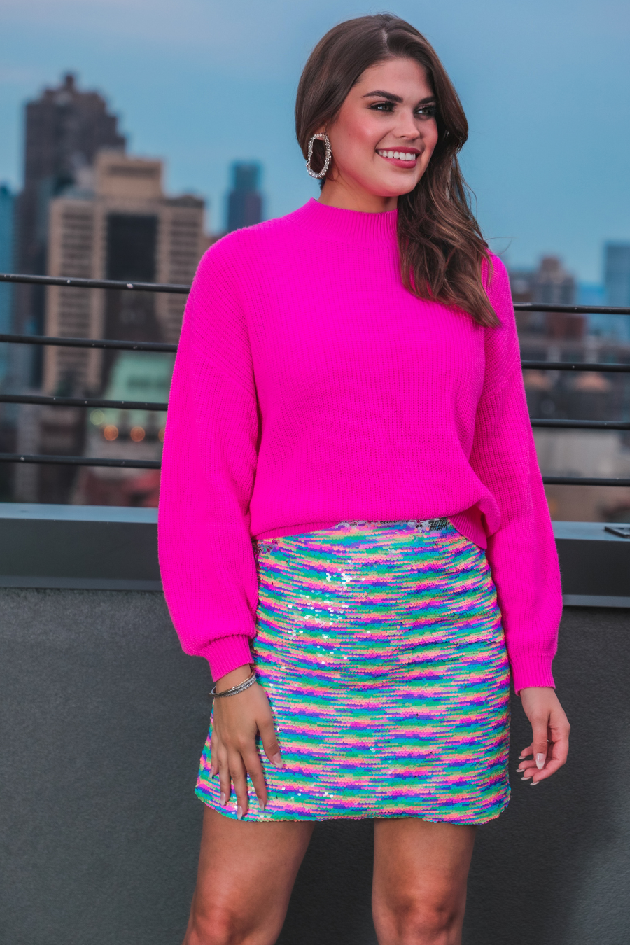 a lightweight high-waisted skirt covered in shimmering multicolor reversible sequins, a smooth interior lining, and a back discreet zipper