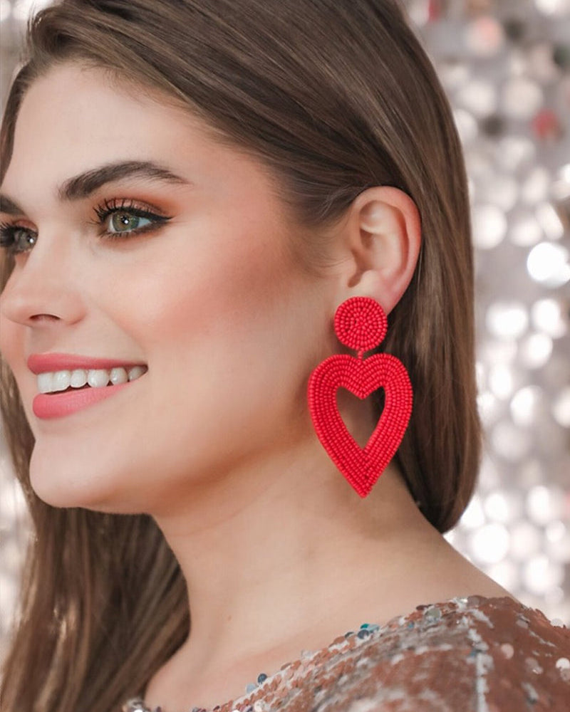 red beaded post stud earrings with matching beaded heart, a comfort replacement earring back, and a plastic disk stopper style in silver and gold