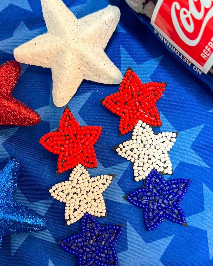 Americana-inspired beaded star earrings with red, white, and blue details, felt backing, and a push-back closure