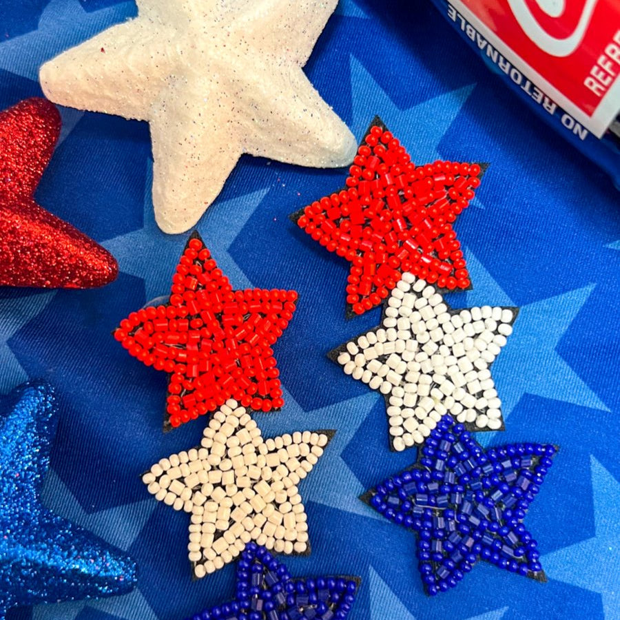 Americana-inspired beaded star earrings with red, white, and blue details, felt backing, and a push-back closure