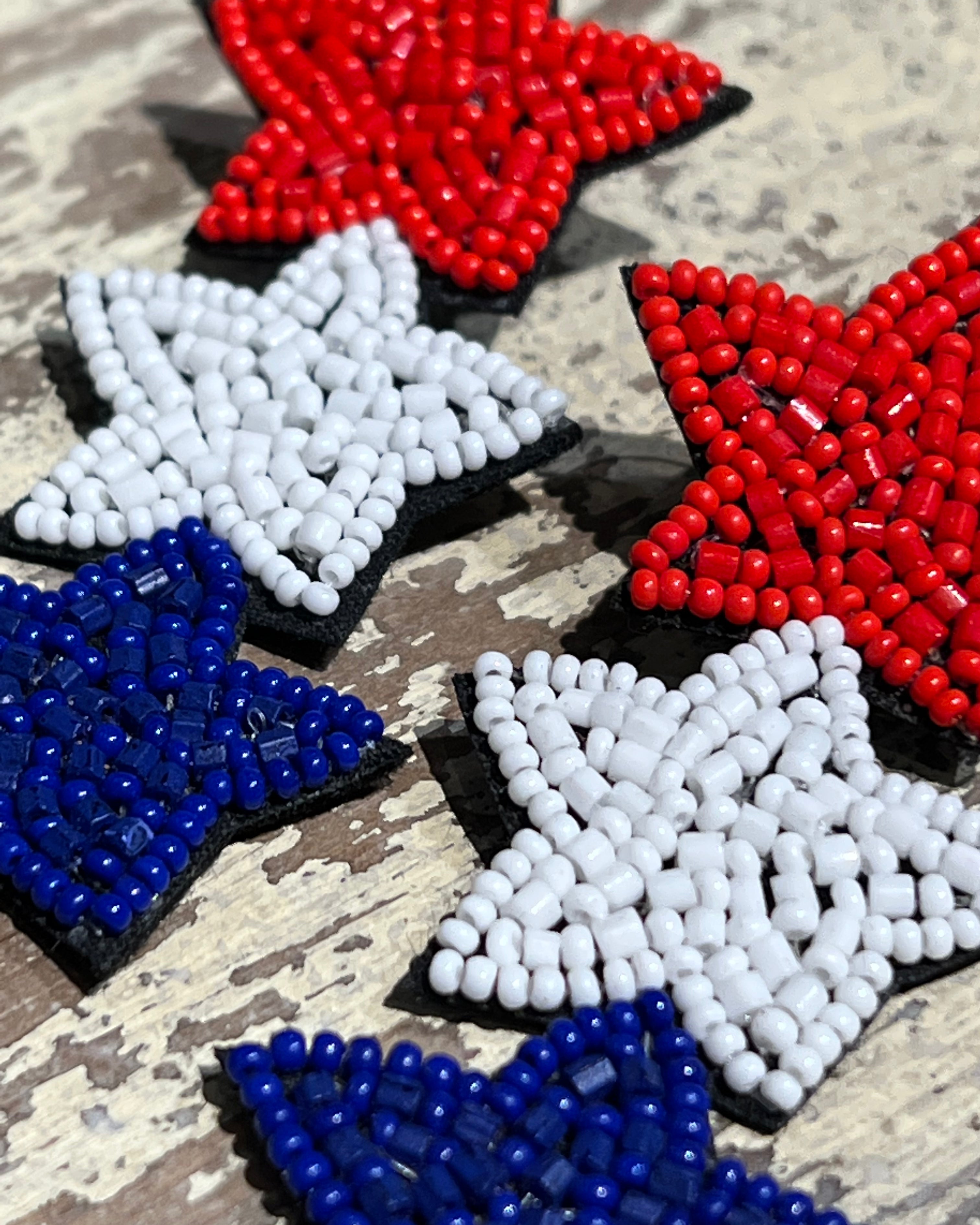 Americana-inspired beaded star earrings with red, white, and blue details, felt backing, and a push-back closure