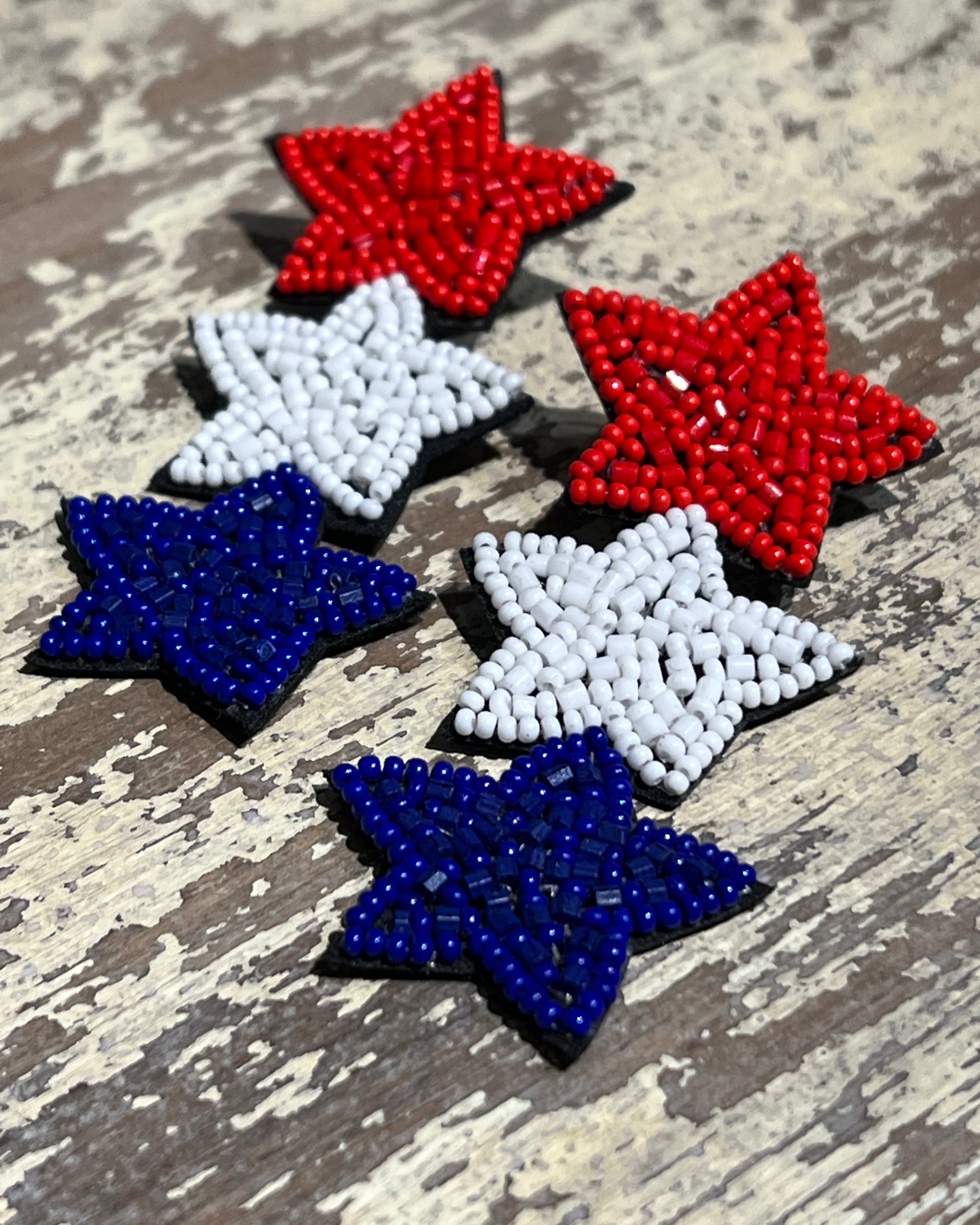 Americana-inspired beaded star earrings with red, white, and blue details, felt backing, and a push-back closure