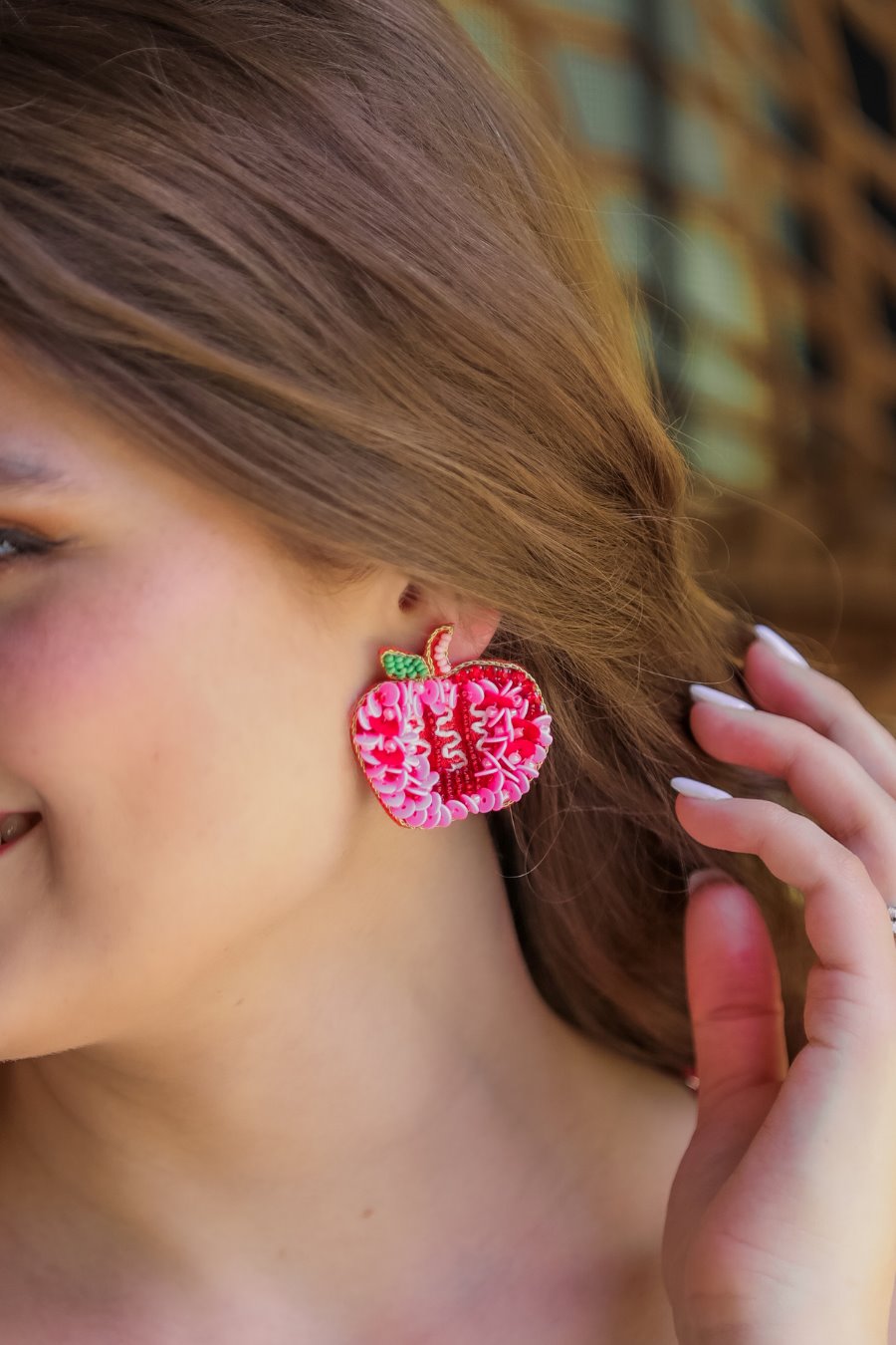 decorative apple shape stud earrings with a comfort back earring, a plastic disc stopper in gold, and a red felt back