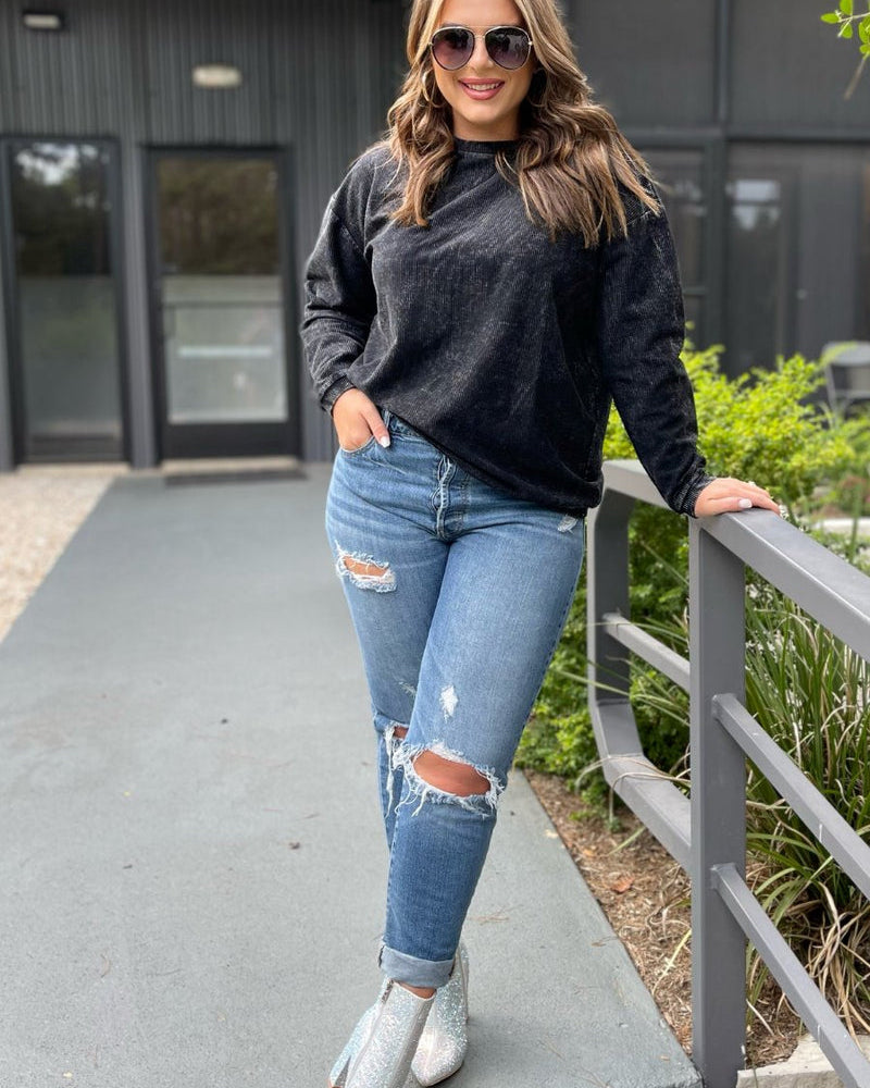 a long-sleeve ribbed textured pullover with a crew neck collar, a vintage wash, and a relaxed fit in black